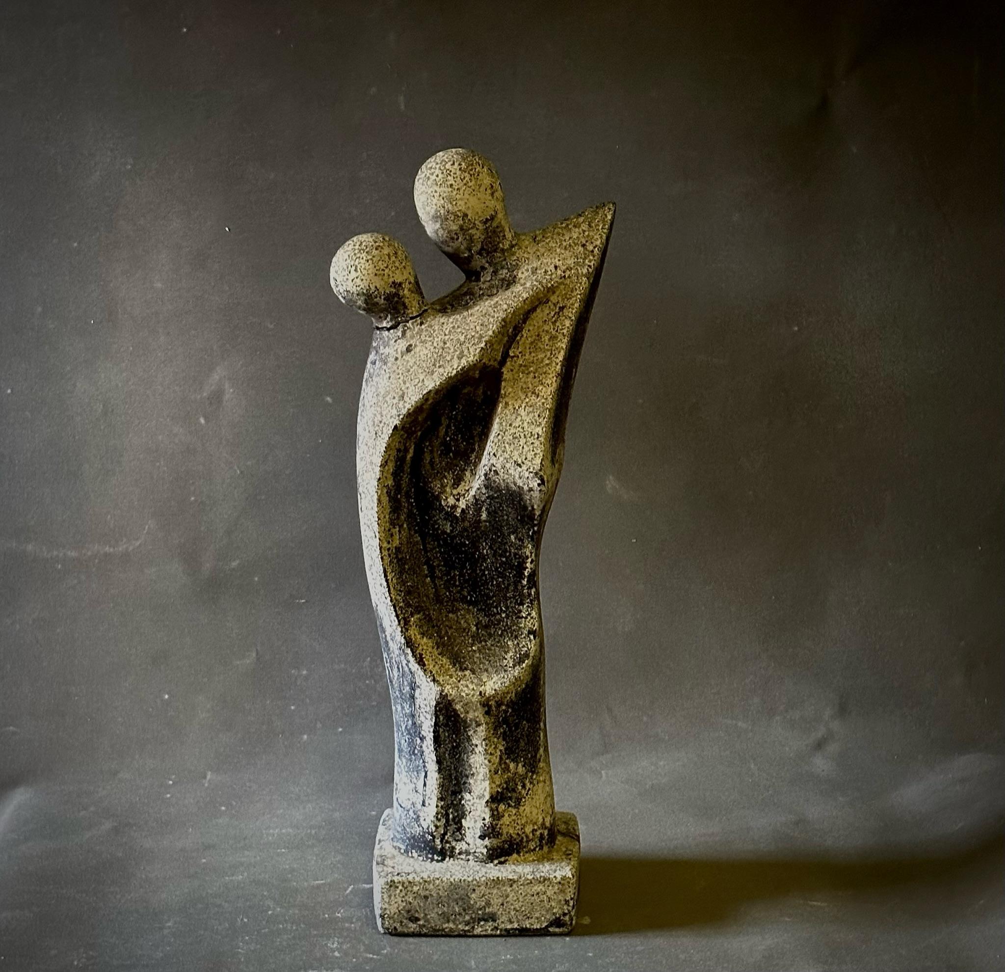 French midcentury carved stone sculpture depicting two figures abstractly rendered in embrace. Strikingly intimate for all its declination towards the anonymous and universal. A powerful, dynamic piece. 

France, circa 1960

Dimensions: 9 W x