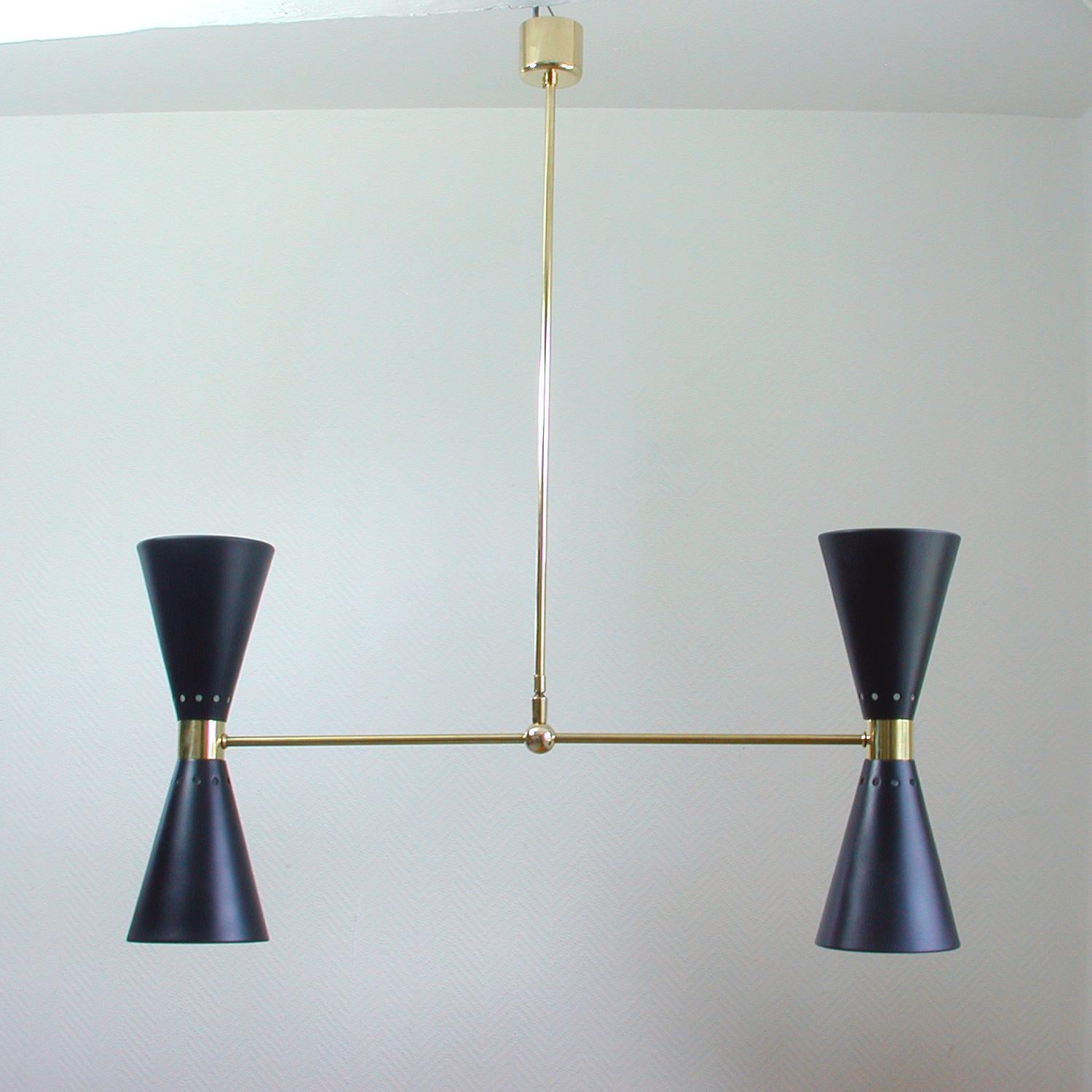 This elegant double cone chandelier was manufactured in France in the 1950s. It is made of brass and has got two black painted aluminum up and down diabolo shades.

Partially restored. Rewired and reelectrified with (4) E14 candelabra based light