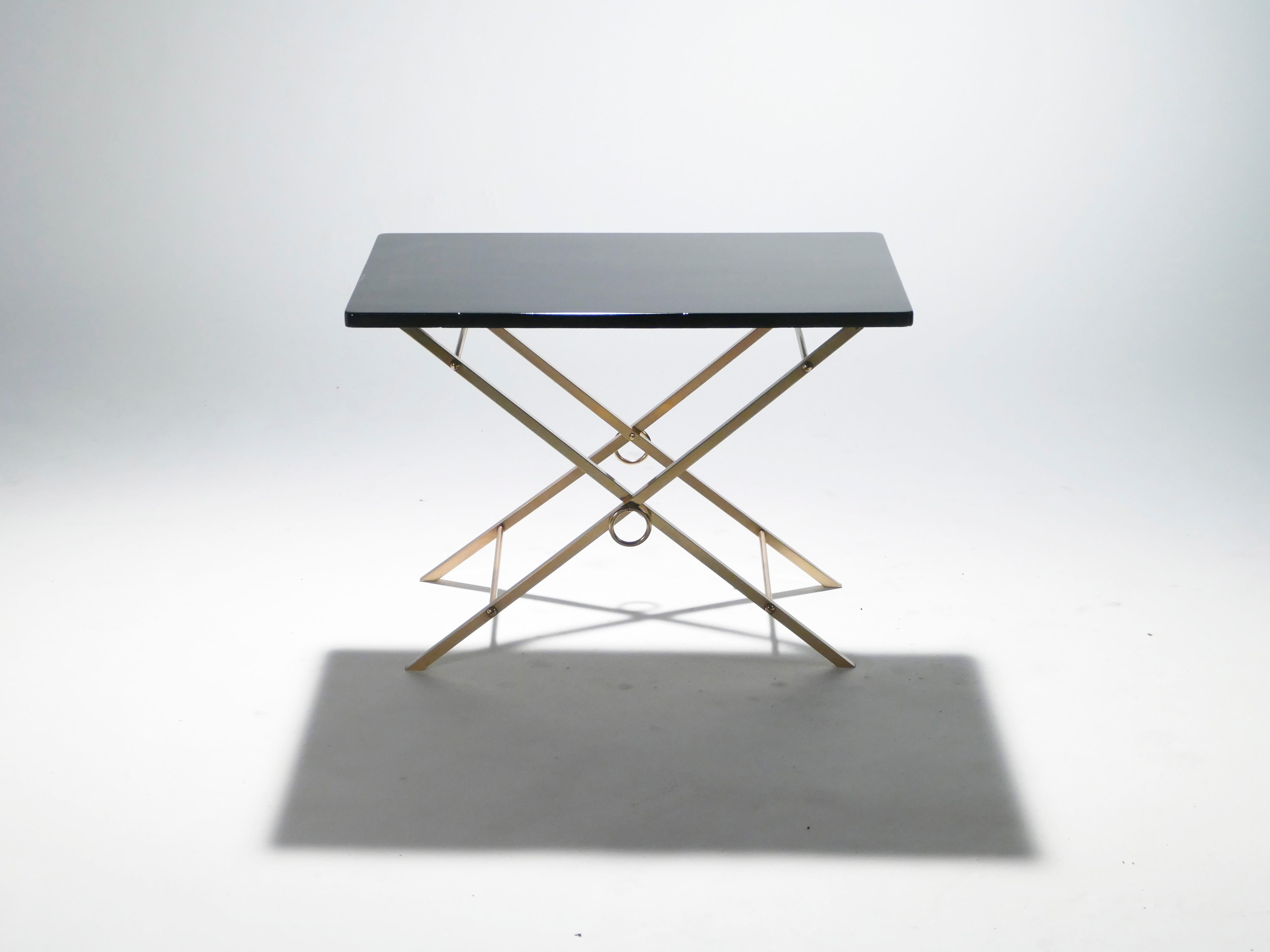 This chic 1960s table emanates sophisticated glamour with its glossy black lacquer top and pristine brass legs. As an unadorned take on both Art Deco and modernism, it is reminiscent of much of Jacques Adnet’s work that continues to feel modern
