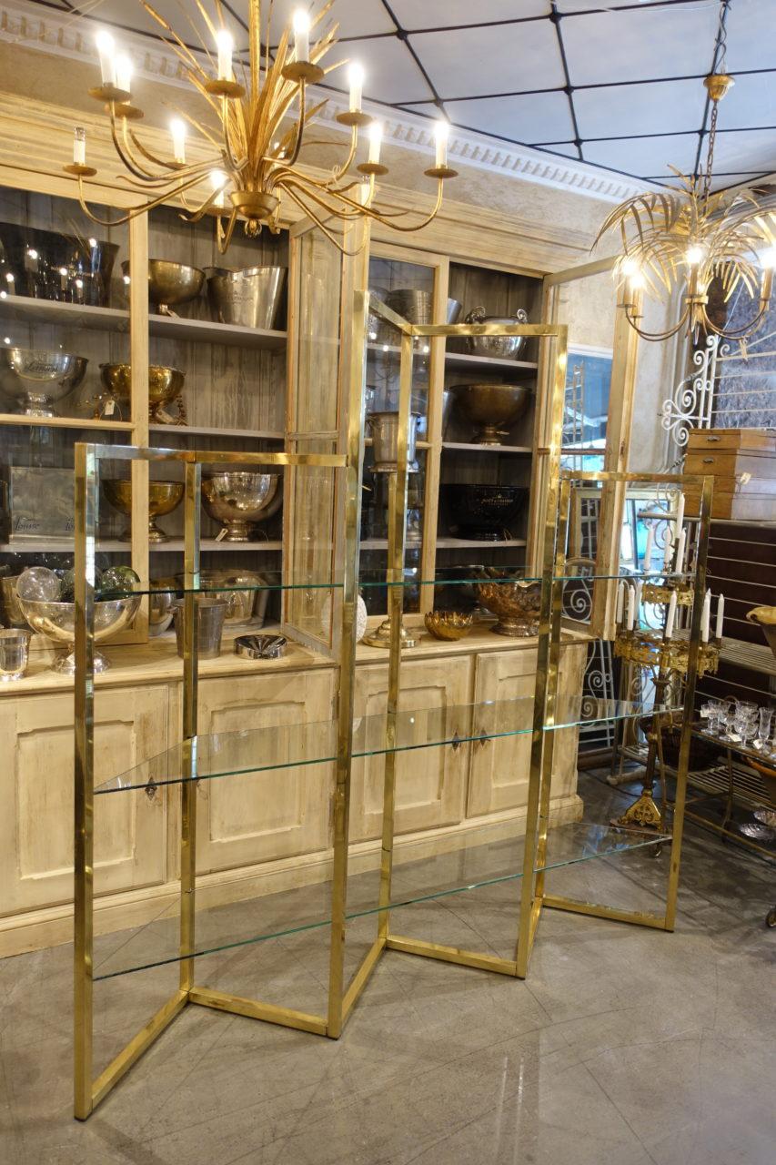 glass and brass shelving unit