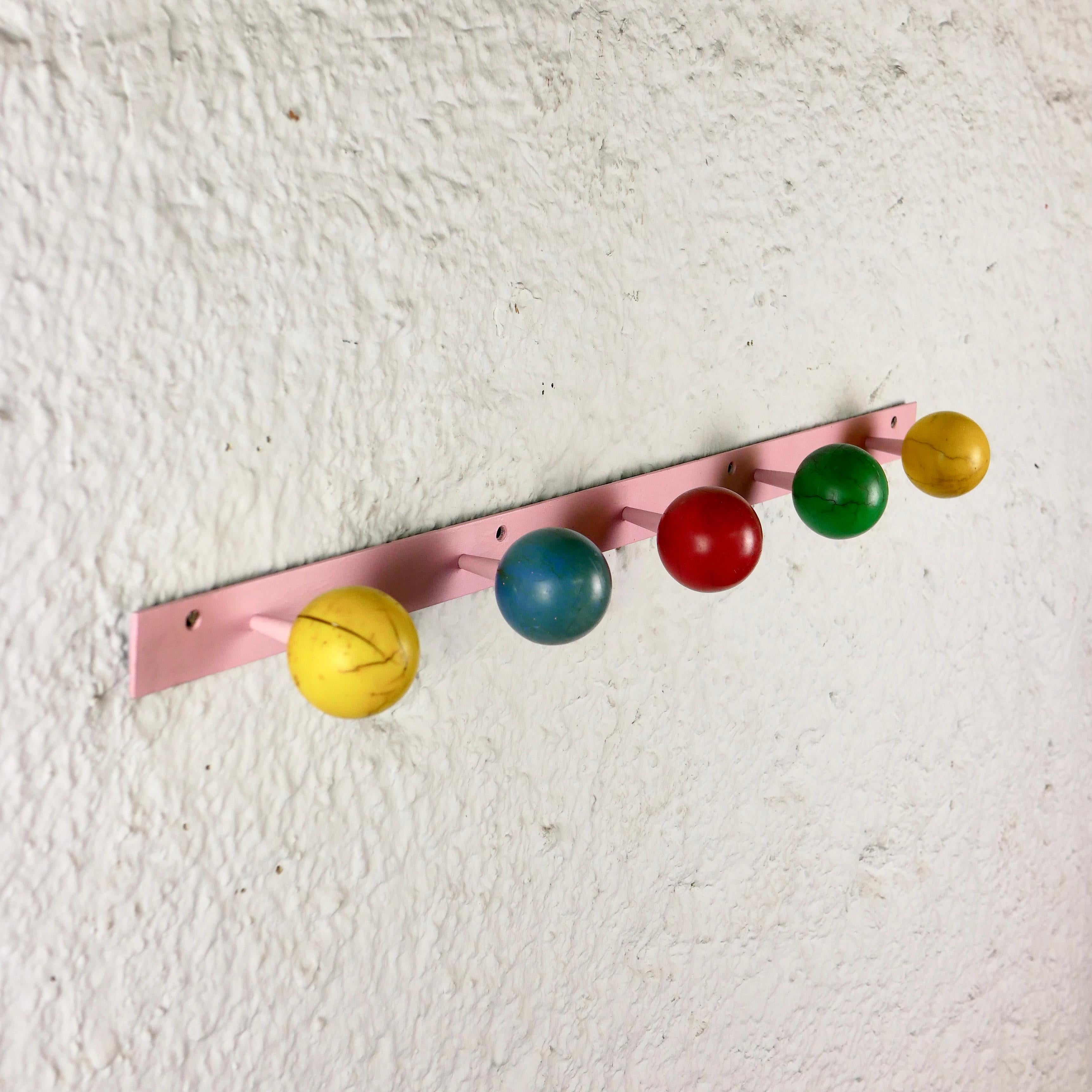 Beautiful and colorful coat hooks with 5 plastic spheres in the style of Roger Feraud, typically from the 1950s.
Heavy iron bar, originally black, but has been painted in pale pink to makes it more cheerful.
Also available, one standing coatrack