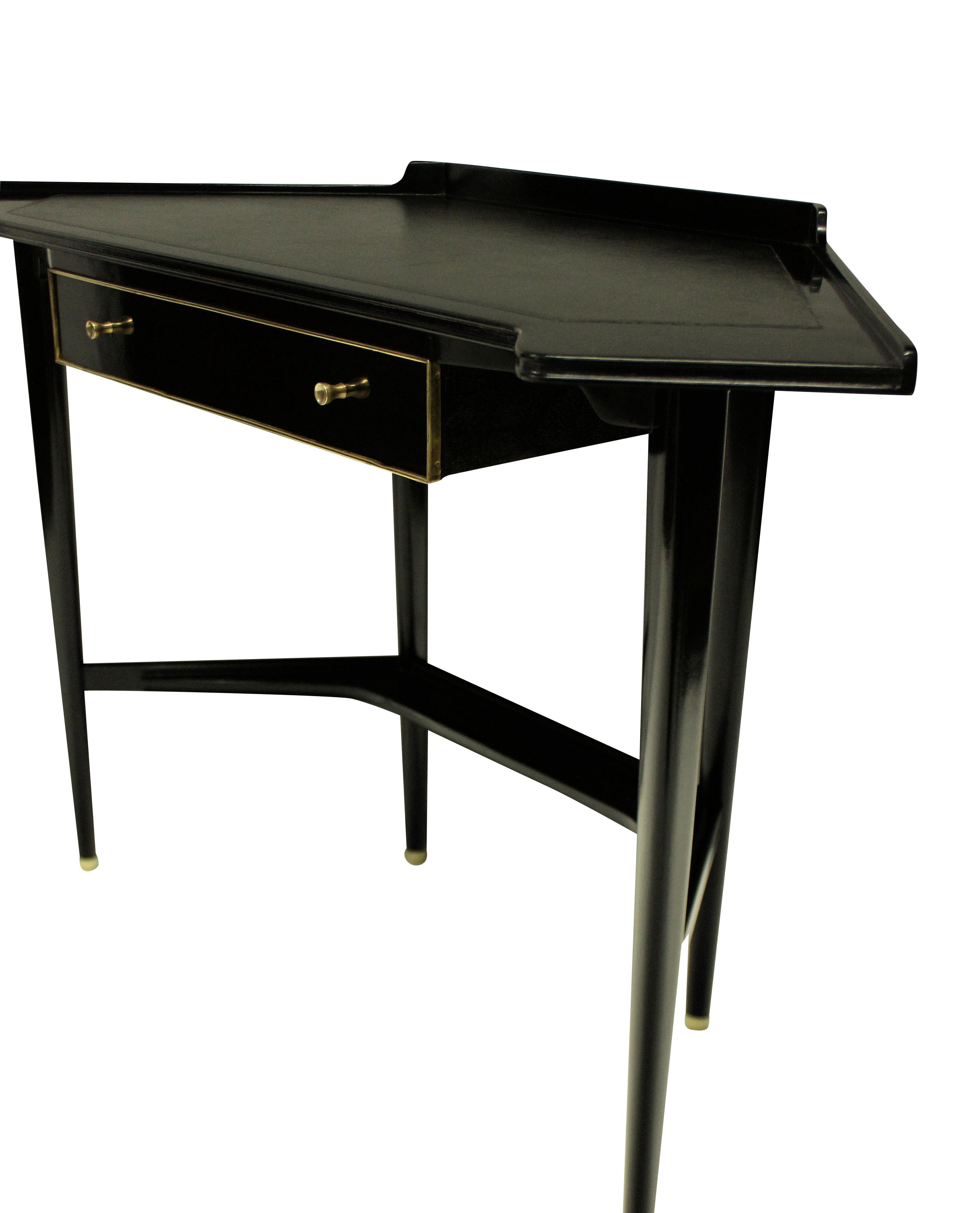 A French mid-century corner desk, ebonized, with brass detailing and a charcoal grey leather top.