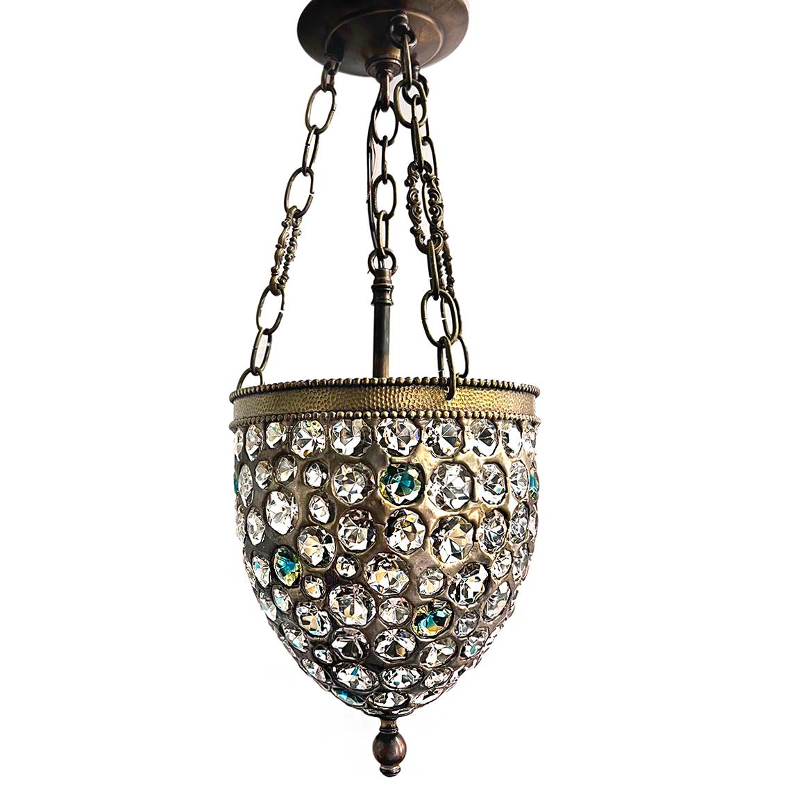 A circa late 1950s French lantern with green and clear crystals, original patina and three interior candelabra lights.

Measurements:
Height of body: 10.5