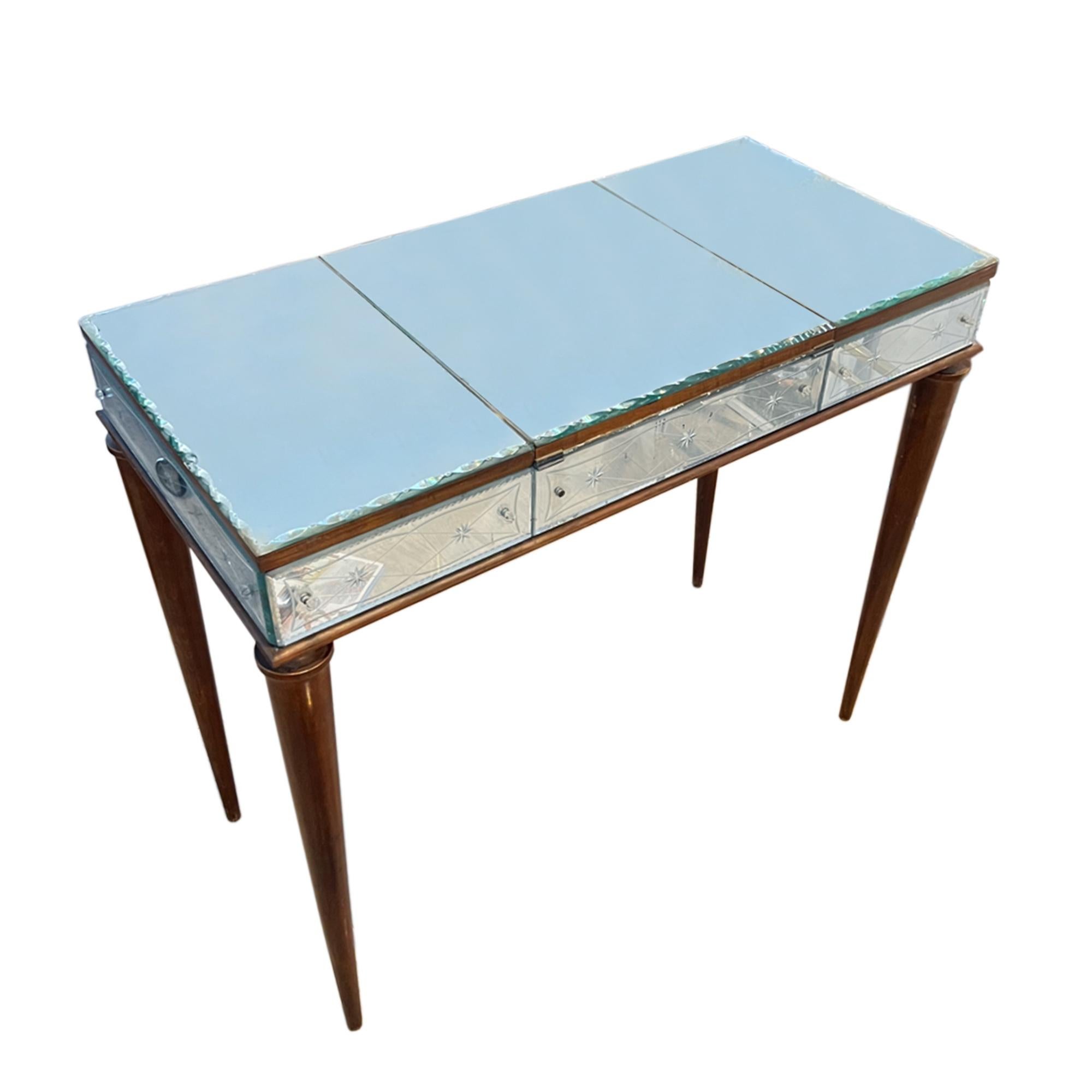 This beautiful dressing table was made in France in the 1960s. 

The top is decorated with a bevelled edge and stars around the sides of the table top. The lid in the middle lifts to reveal a mirror and storage space. The mirror is 31.5cm high and