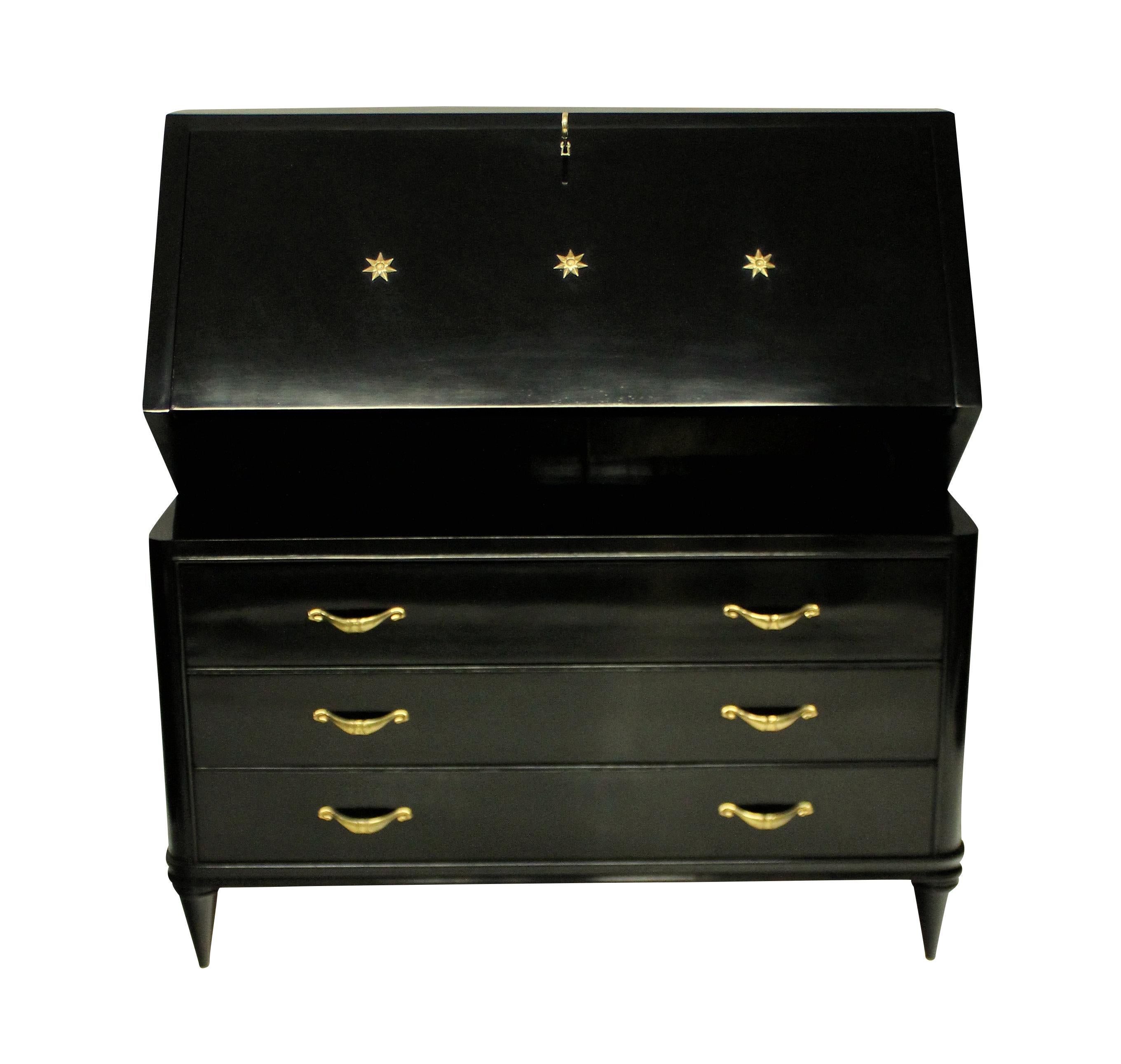 An elegant French midcentury ebonised bureau, with three drawers and a fall front desk. With swag shaped brass handles, a decorative key and star motif to the door.