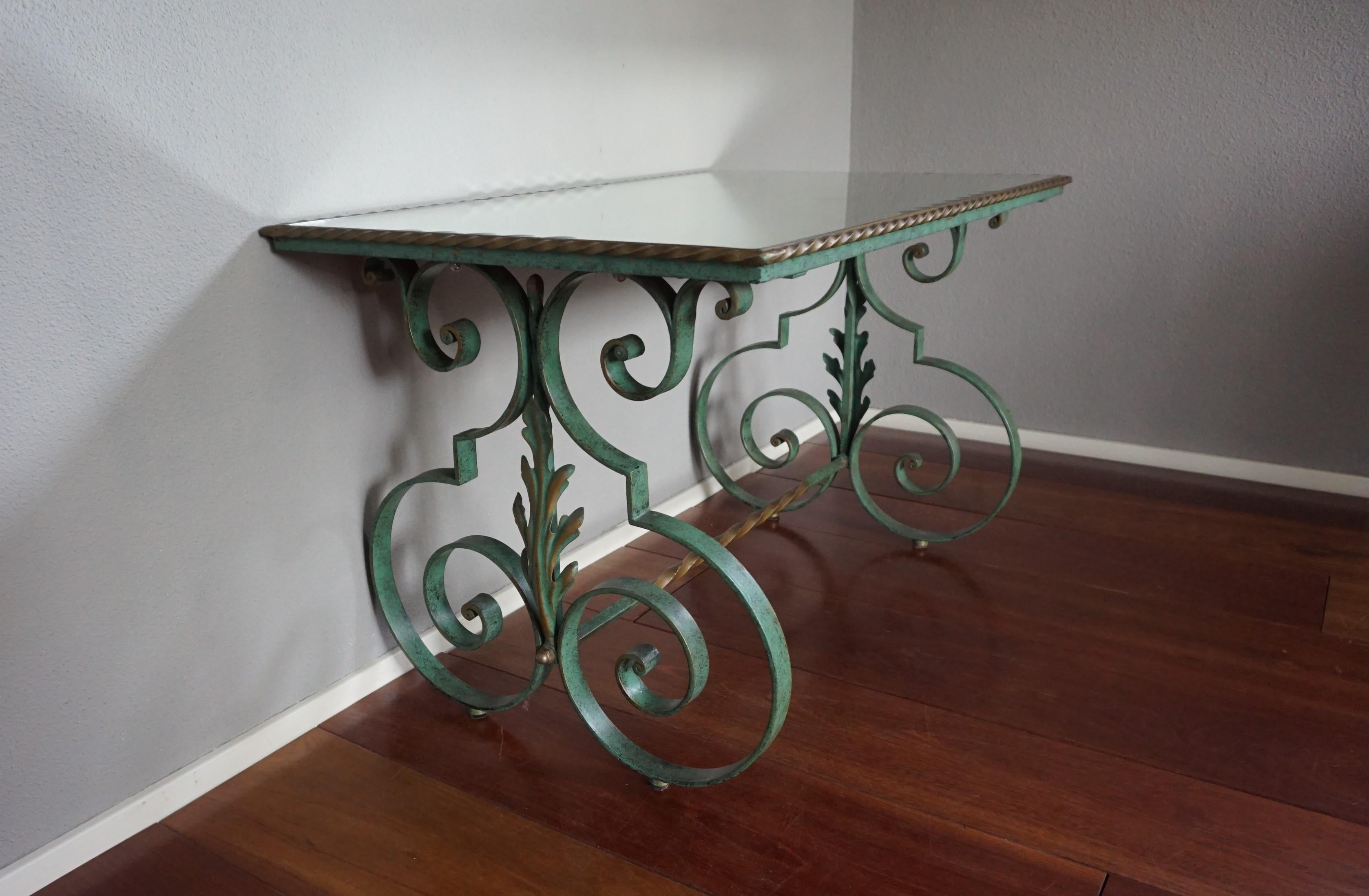 Handcrafted wrought iron table with a bronze patina and beveled mirror top.

If you are looking for an elegant table to grace your living space or office then this hand-crafted specimen from mid 20th century France could be perfect for you. Apart