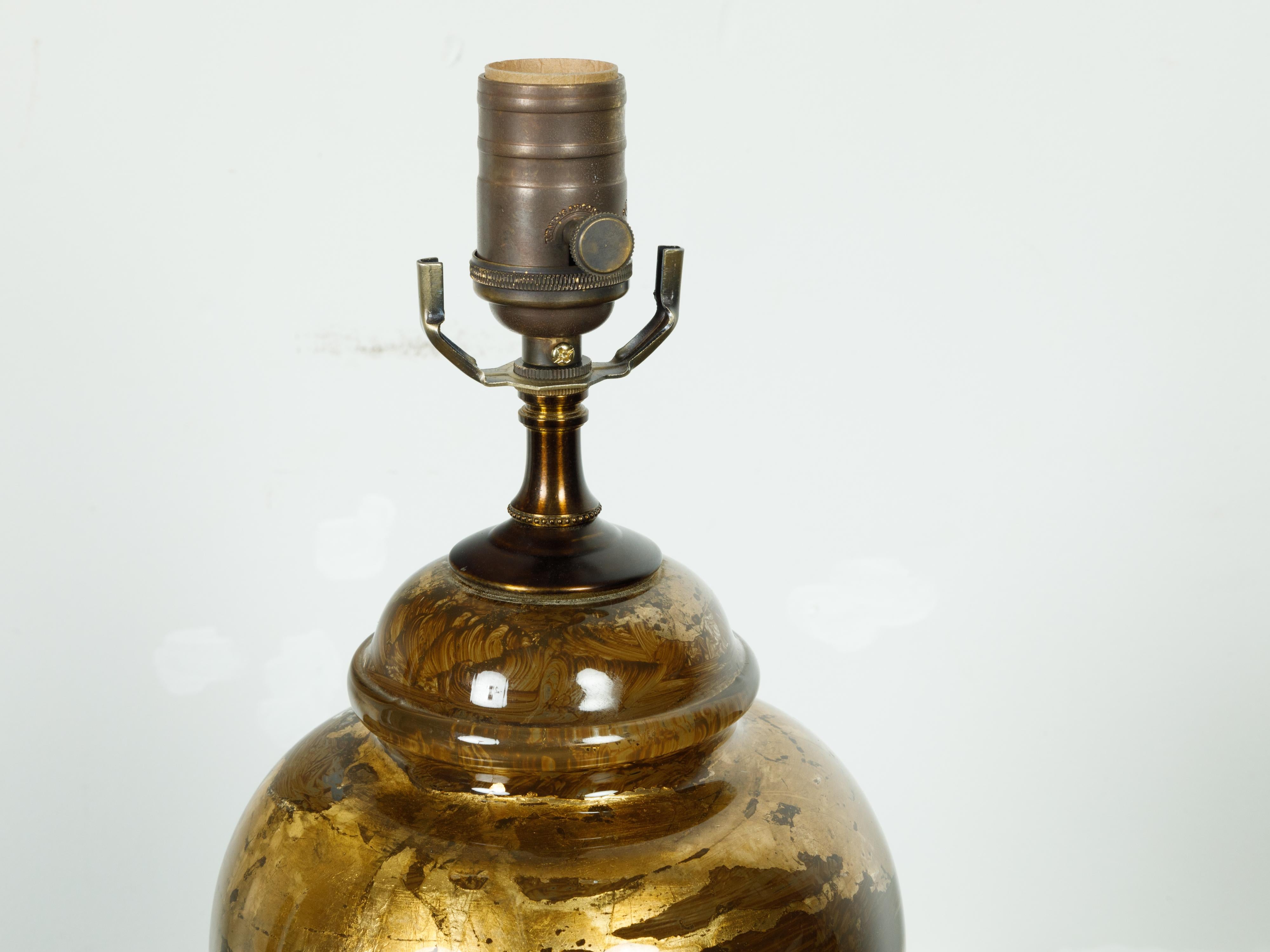 Französische Tischlampe aus Glas und Blattgold aus der Mitte des 20. Jahrhunderts, auf rundem Sockel. Diese Tischleuchte, die in Frankreich in der Mitte des Jahrhunderts geschaffen wurde, ist neu für die USA verdrahtet worden und hat einen