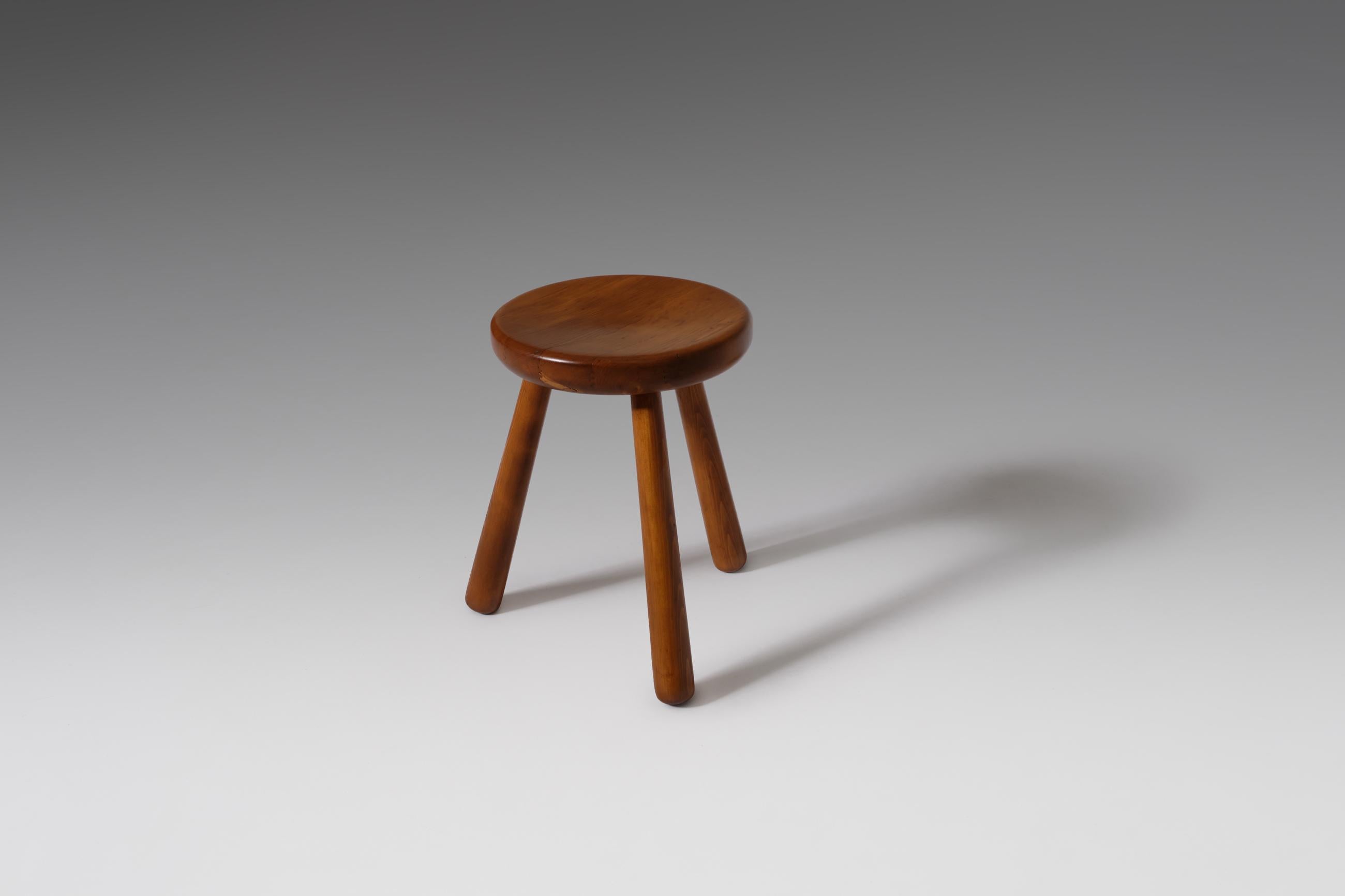 French Mid-Century Modern stool, France, 1960s. Striking design made of solid pine with nice elegant curved lines and bulky legs which results in a playful look. The stool show similarities with the stools designed by Charlotte Perriand for the Les