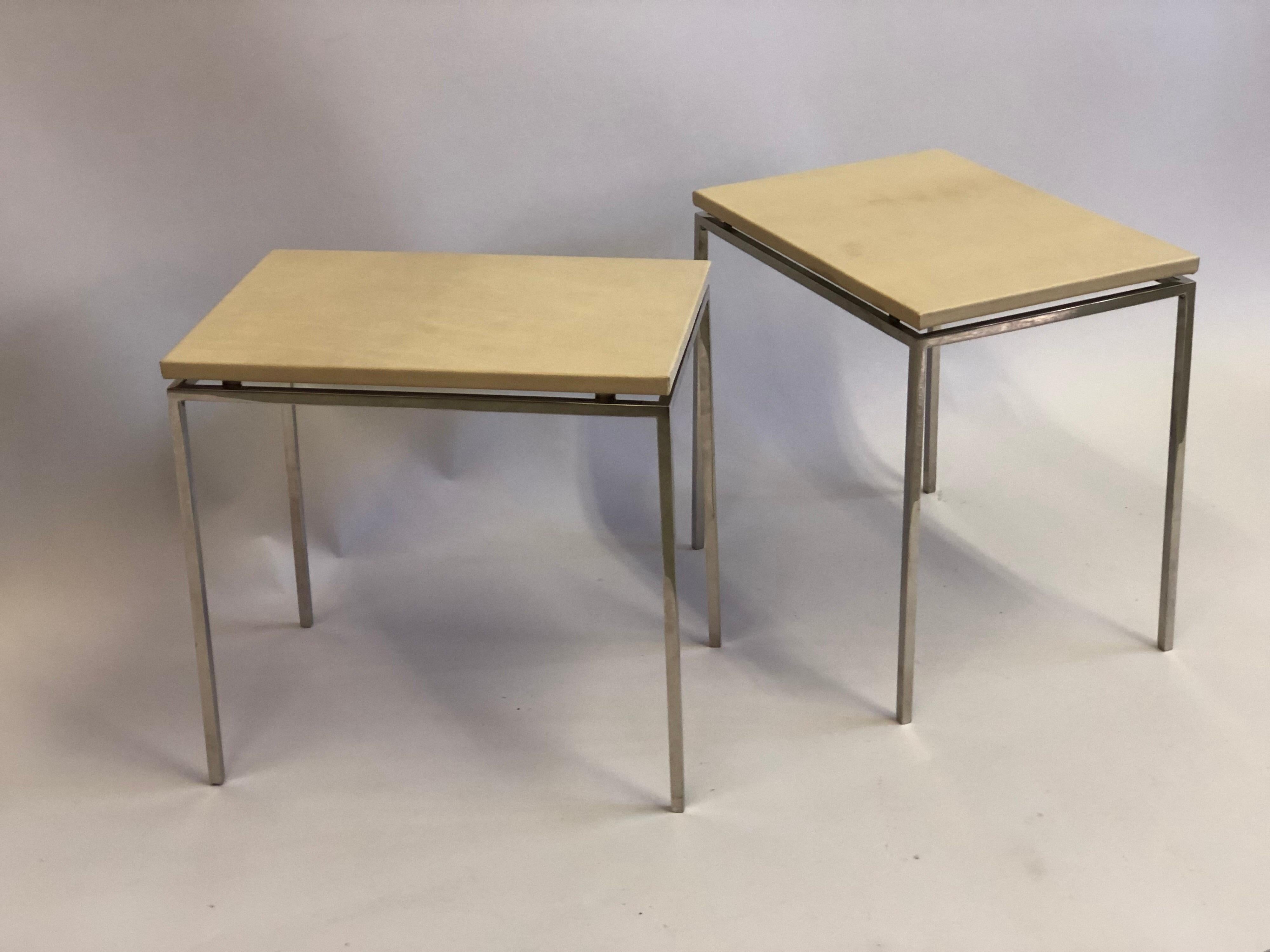 Elegant pair of French Mid-Century Modern cantilevered nickel and parchment leather side / end tables / gueridon attributed to Maison Ramsay. 

The pieces feature delicate nickel metal frames with tops of parchment leather cantilevered above them.