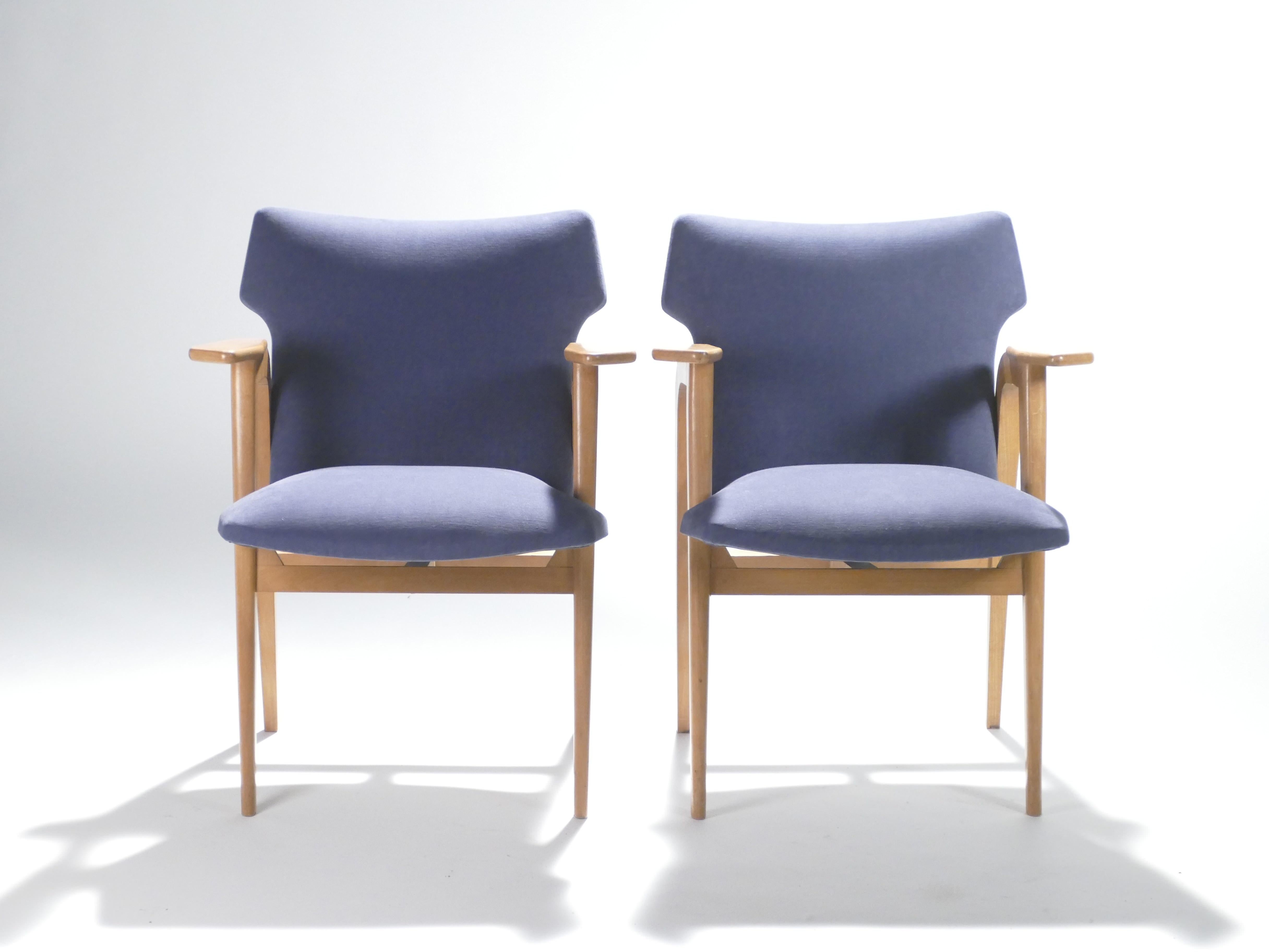 These elegant compass armchairs are sure to add an element of modernist glamor to any room in your home. Designed by Roger Landault in the late 1950s, with shapely solid oak frames, these armchairs are wonderful examples of midcentury French