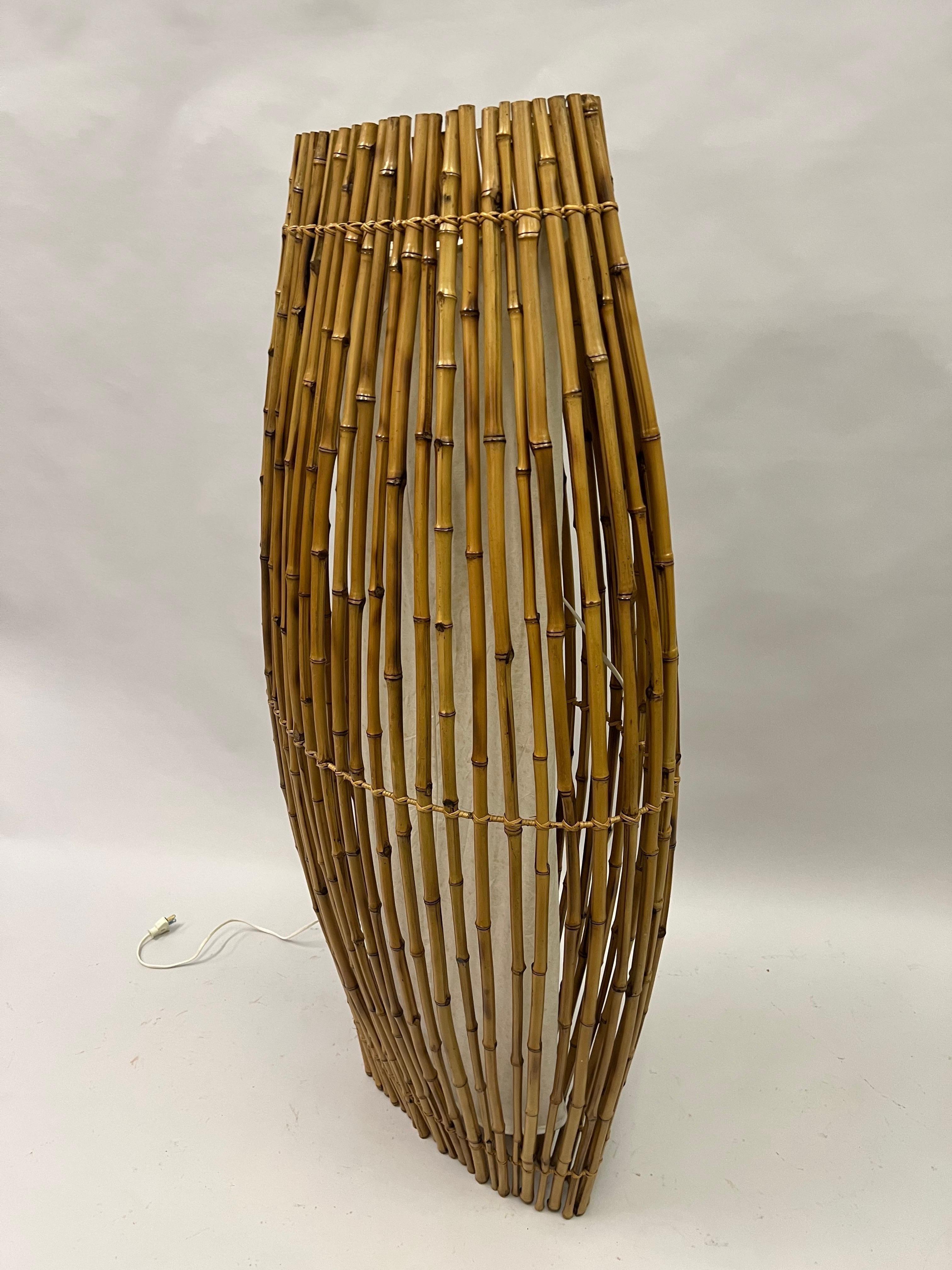 A Magical, Rare French Mid-Century Modern Craftsman Floor Lamp / Light Sculpture in Rattan Attributed to Janine Abraham and Dirk Jan Roi. This minimalist sculpture reflects 1960's culture with its pure, natural aesthetic that was an integral part of