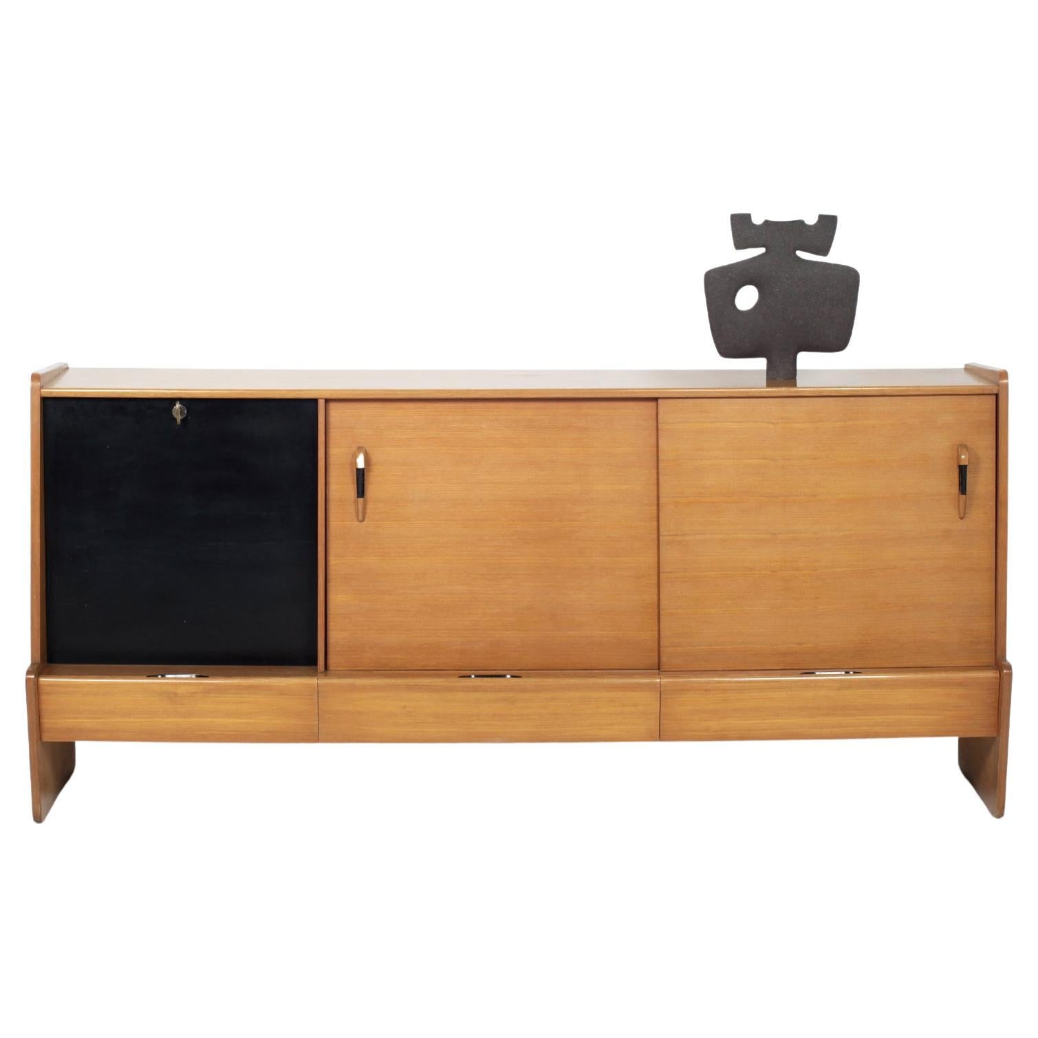 French modernist sideboard by Roche Bobois circa 1950
Two sliding doors with shelves
Three drawers and a bar
Nice blackened wood details.