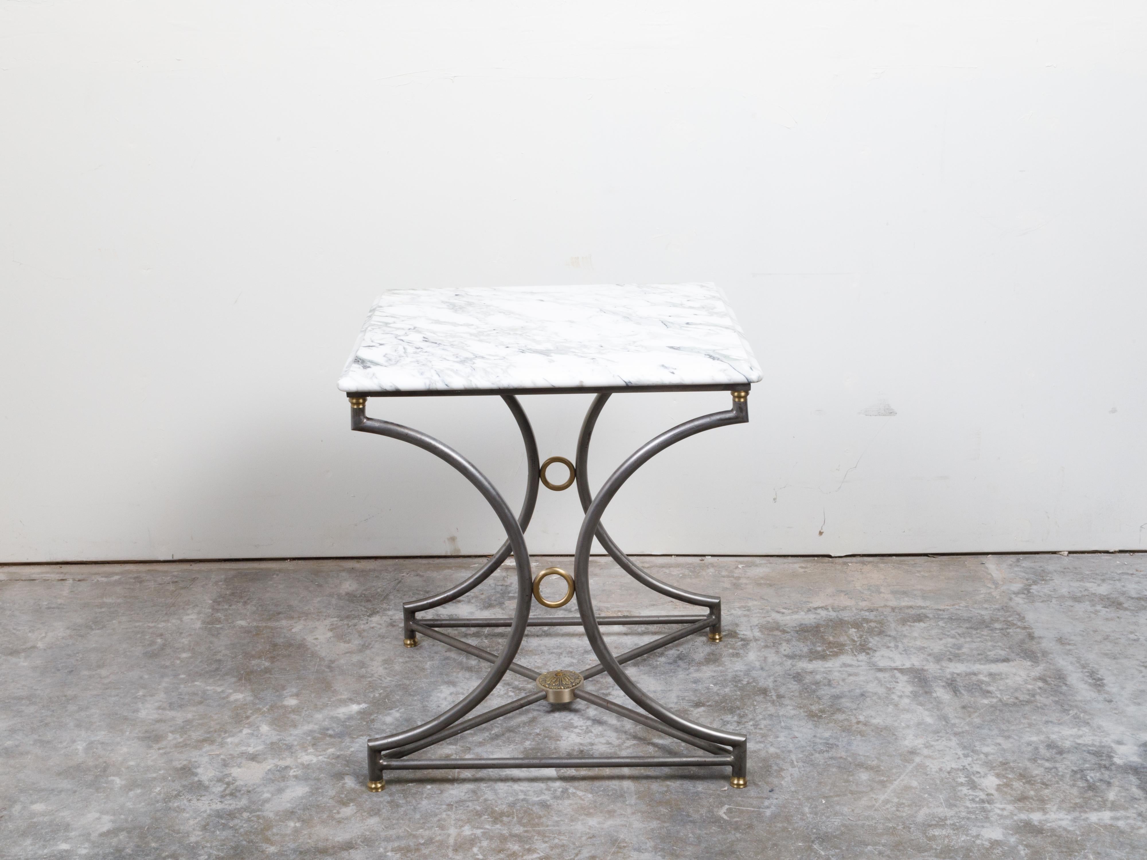 A French steel and bronze console table from the mid 20th century, with marble top and rosette medallion. Created in France during the mid-century period, this console table features a square-shaped white veined marble top with rounded corners and