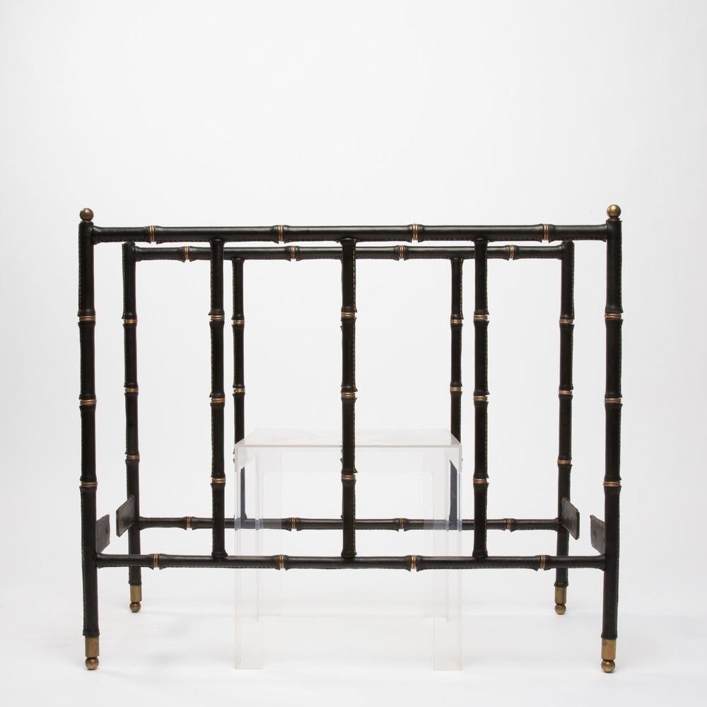 A black steel structure daybed by Jacques Adnet.
The structure is covered by black leather saddle stiched.
Bronze rings giving an impression of bamboo (faux bamboo) decorated the whole.

Please note that the mattress and the photographed