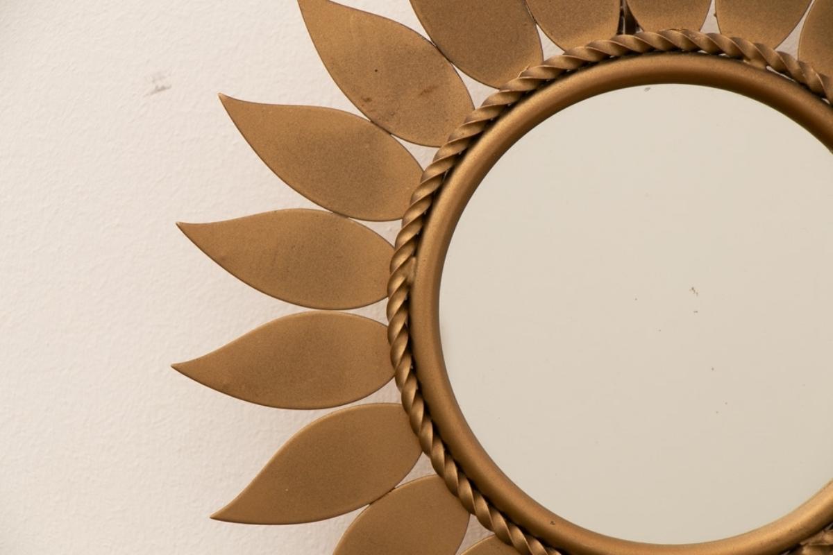 A French midcentury brass sunflower wall mirror by Chaty Vallauris with circular mirror and rope twist border.