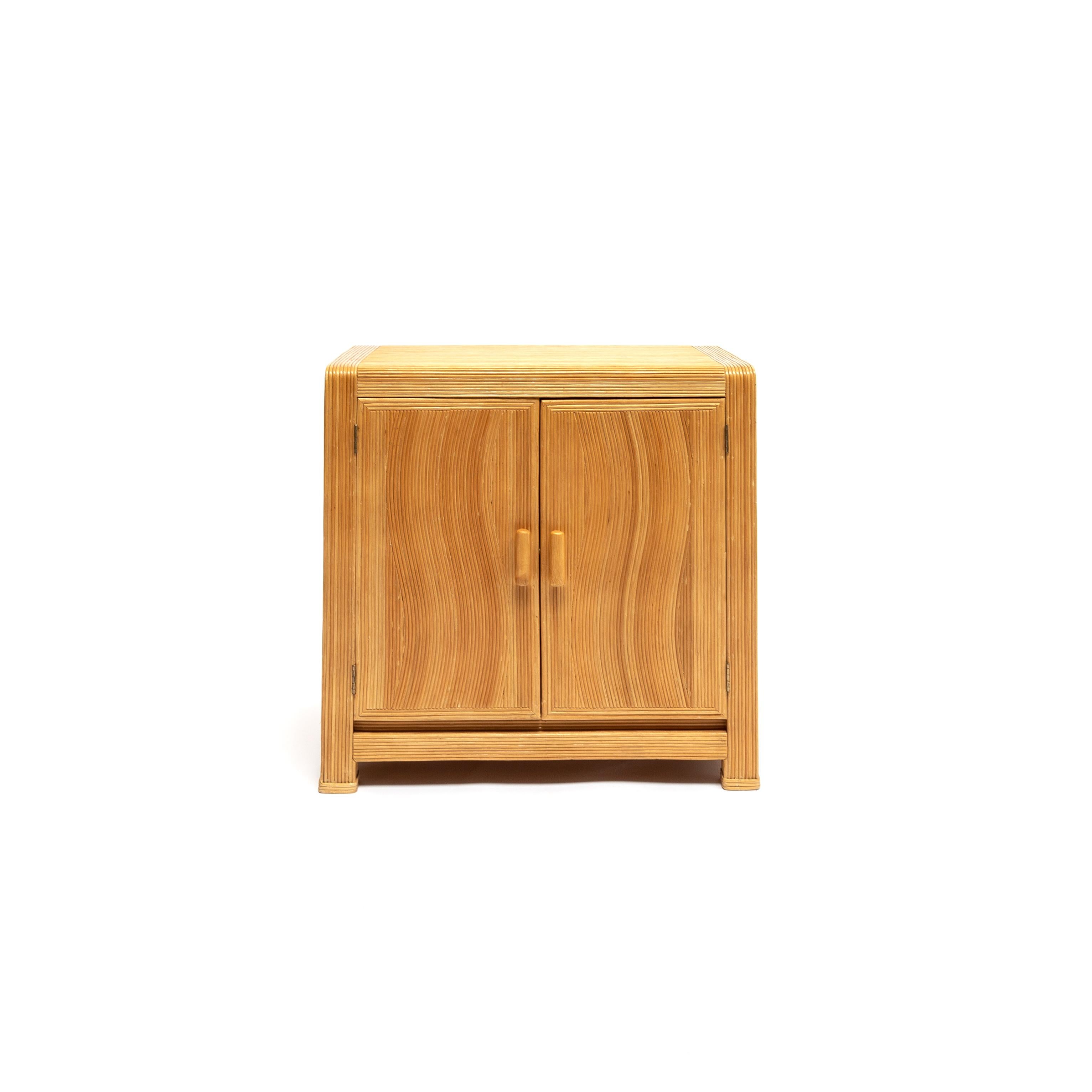 A vintage compact bamboo cabinet. Wavy applied split bamboo veneer over solid wood case construction. This piece is a great way to introduce warmth and texture into your space, French, circa 1950.