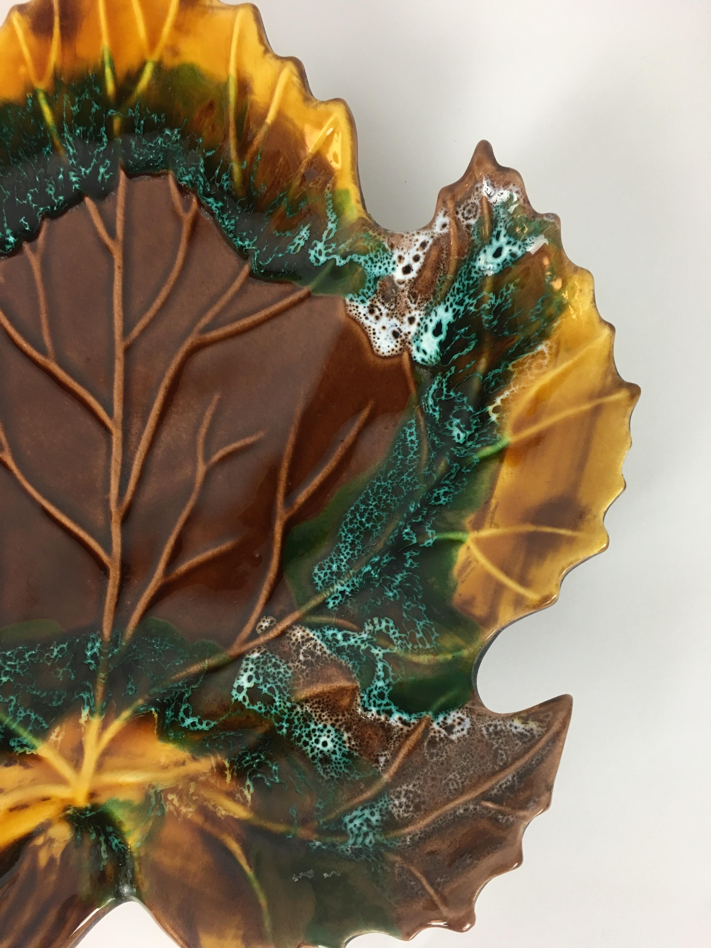Impressive and colorful leaf shaped glazed ceramic platter, serving tray or centerpiece manufactured by Vallauris France, pottery makers, circa 1950s.

Useful as centerpiece, fruit or dessert platter and serving tray. Its generous size, design and
