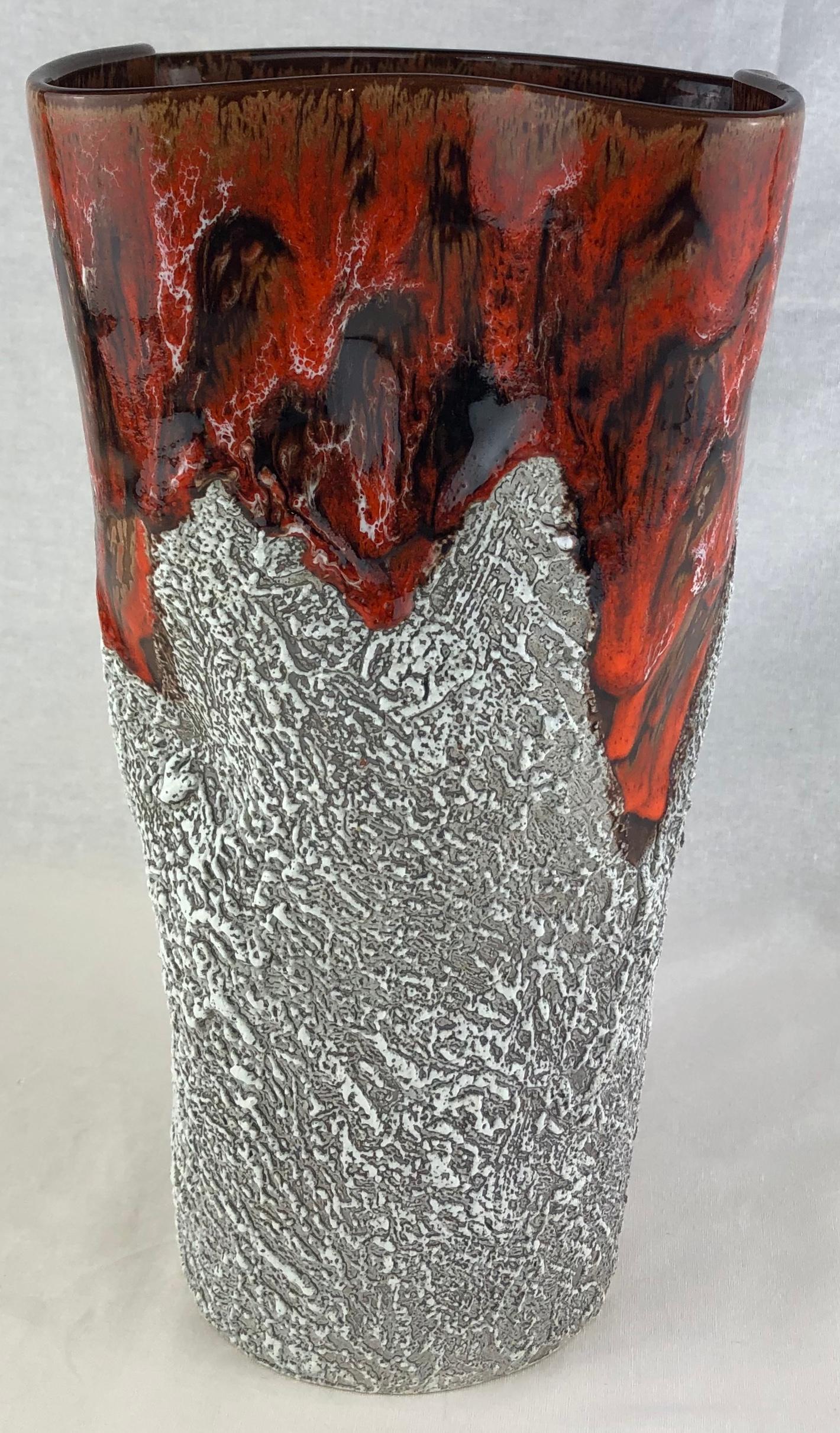 Beautiful ceramic vase from Vallauris, France handcrafted and glazed. The lava style design is placed on a white background with overlays of grey and brown hues.

Circa 1950s, designed and created in the manner of both Charles Cart. 

Charles Cart