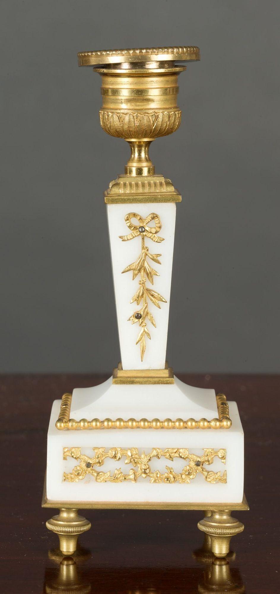 Miniature French white marble garniture with gilded beaded and frieze decoration.
 
Enamel dial with Arabic numerals and original gilded hands.
 
Eight day French movement with platform escapement. C.1890
The clock measures: Height 7.25 inches      