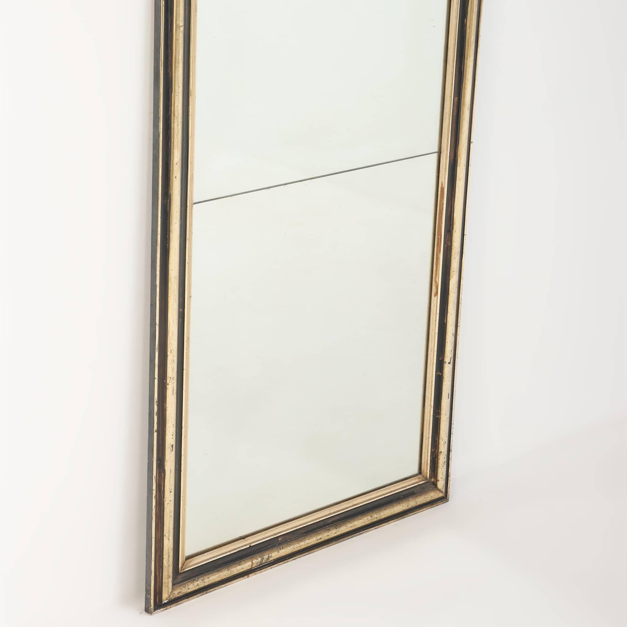 French mirror with partial ebonized and gilt frame C 1860. The gilding is a silvery gold. The back bearing the label of F. Toute Rouen.