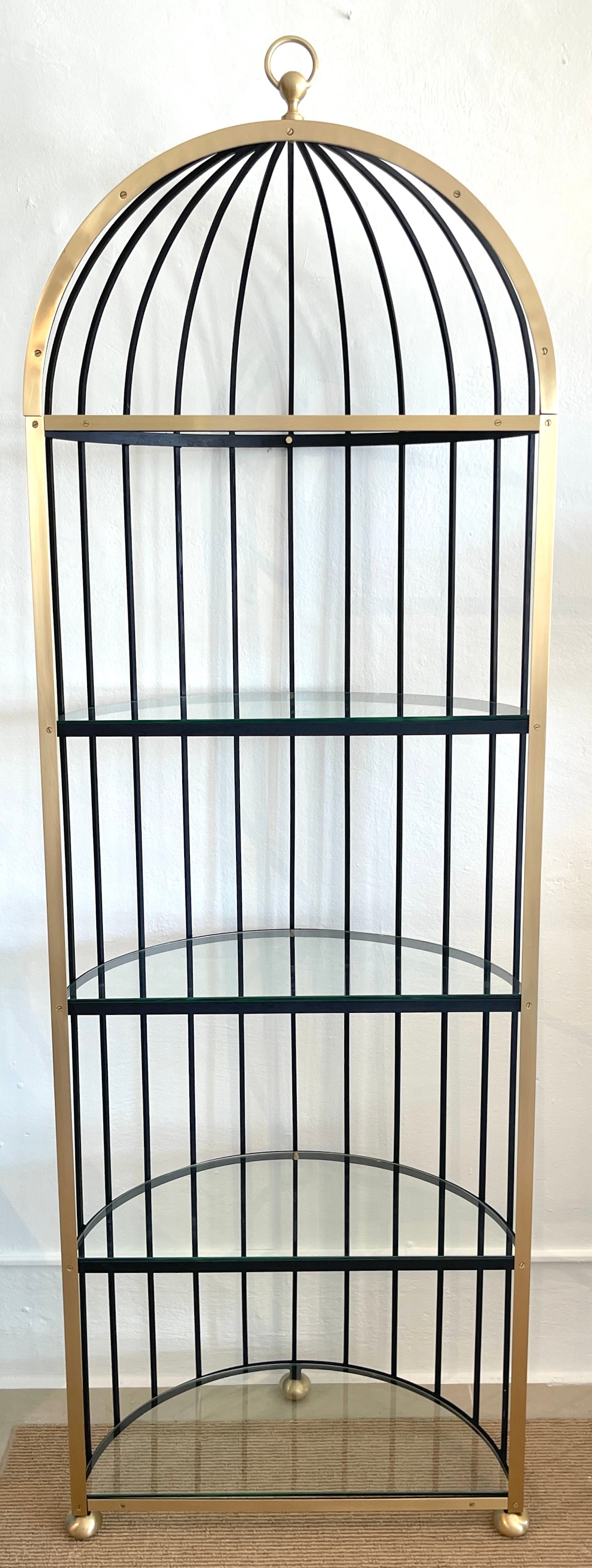 French Sculptural 'Brid Cage' Motif Brass and Iron Étagère/ Shelf -Restored
France, Circa 1970s

A standout, French modern brass and iron etagere, showing influences of whimsy and Surrealism. Depicting a half model of a birdcage, with brass