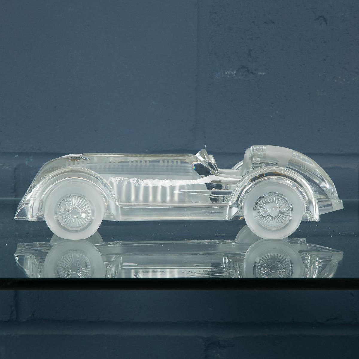 A rare model race car designed by Xavier Froissart and realized by Daum, France, circa 1985. A mixture of frosted and polished glass give a wonderful texture to this sculpture, recalling the lines of a Le Mans single seater race-car from the 1940s.