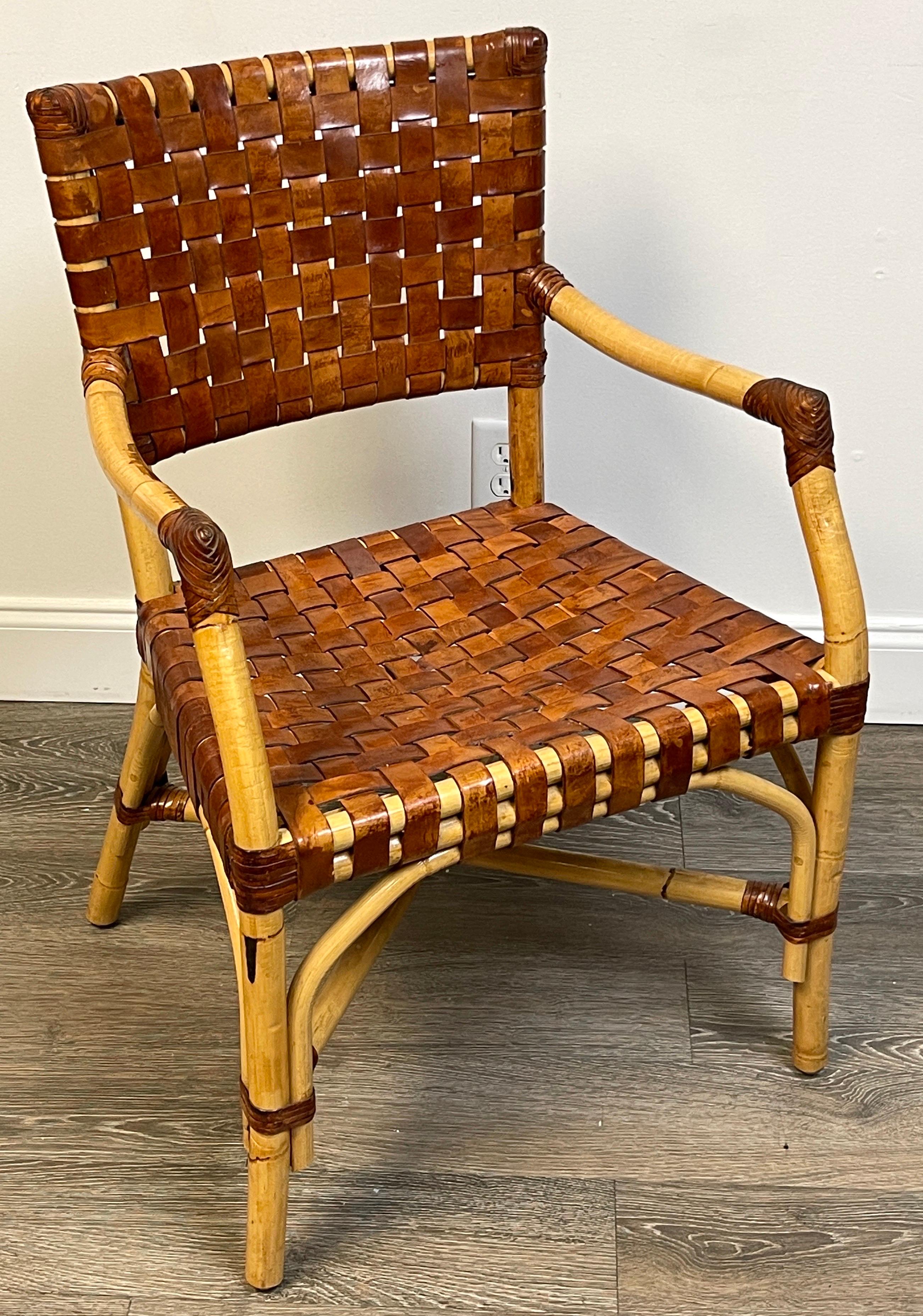 French modern bamboo & woven saddle leather armchair, 
France, Circa 1960s

A unique beautiful model, well cared for this chair retains the original woven saddle leather backrest and seat. The perfect accent or desk chair. 

The chair measures