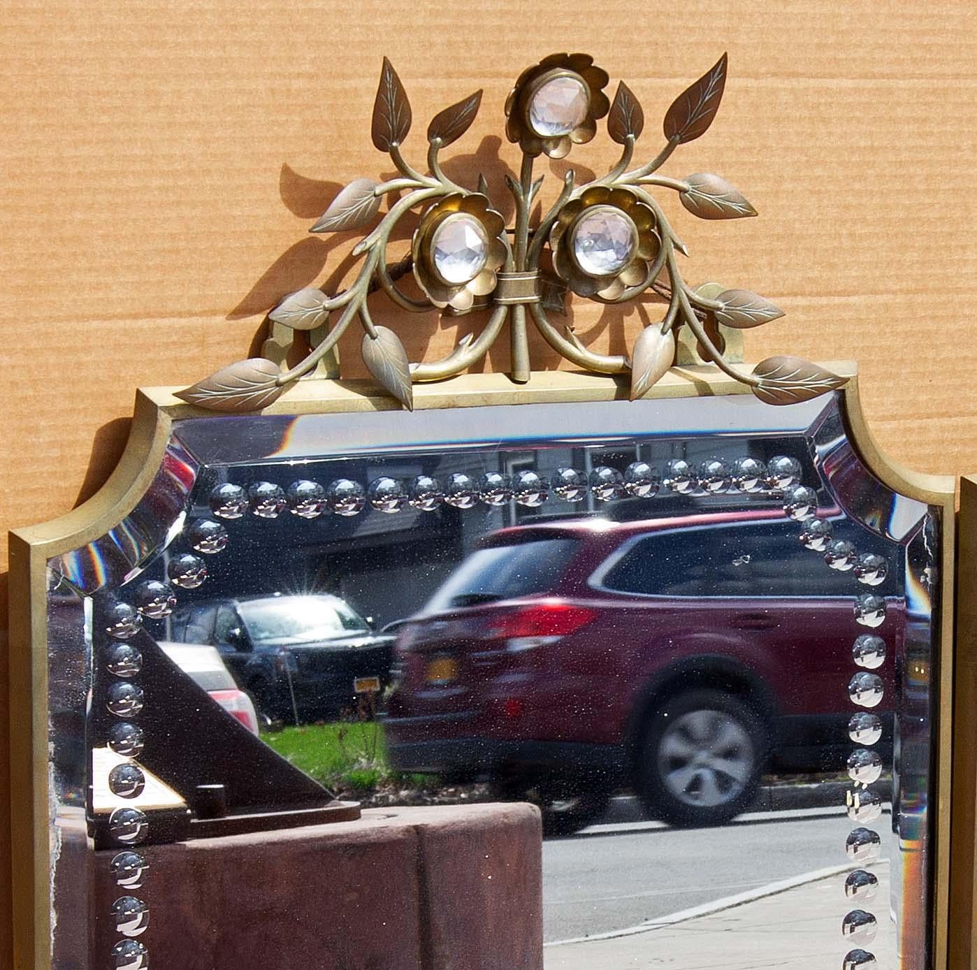 Elegant French modern console mirror. Unusual and refined design. Solid brass frame. Cut glass floral decorations. fine beveled mirror. Solid wood backing, circa 1940s. Available as a pair.






















Hollywood regency moderne art deco
