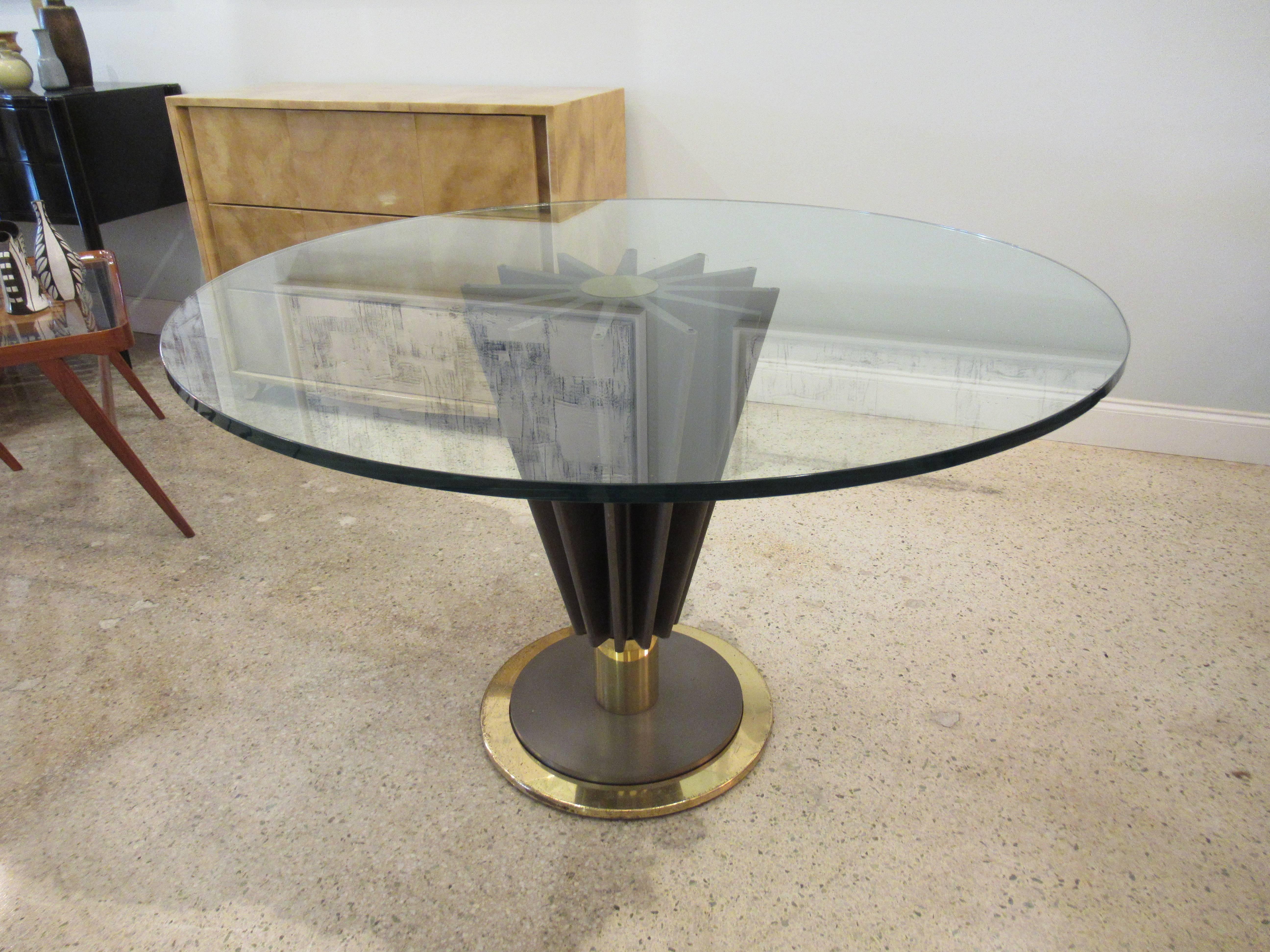 The glass top above a central brass medallion with signature Pierre Cardin, and radiation tapering steel fins, terminating with a cylinder, on a circular chrome and brass base.
The glass top can be from 36