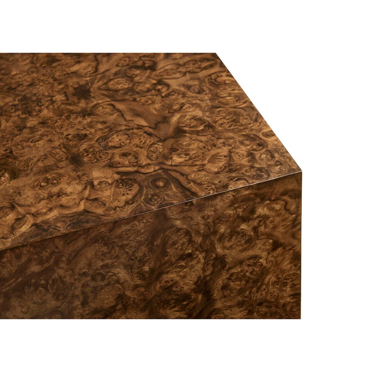 A stunning piece showcasing the timeless beauty of book-matched walnut burl veneer. The square table design is enhanced by a unique rounded radius end in one corner, lending a modern yet refined aesthetic to the piece. This distinctive feature not