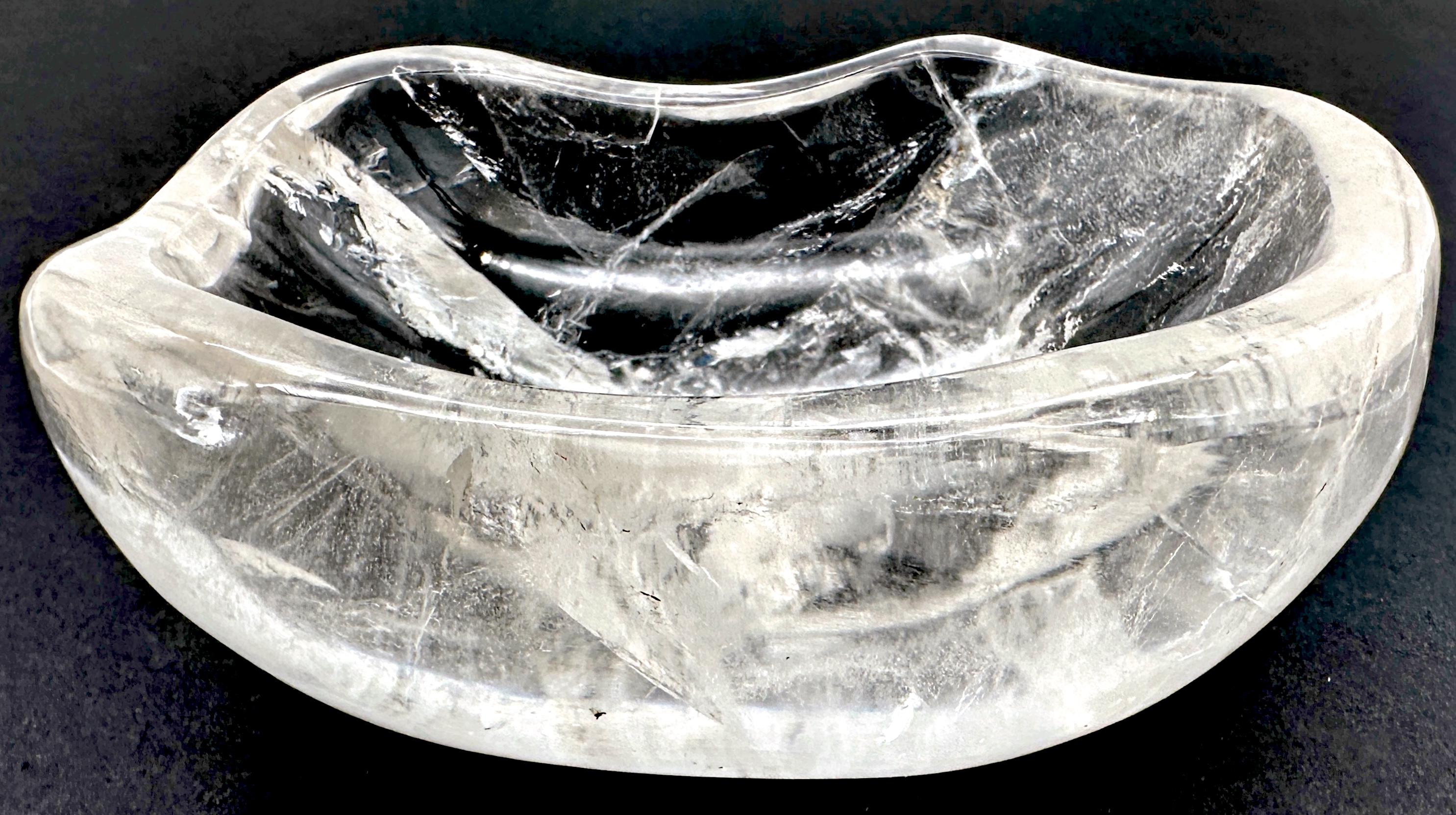 French Modern Carved Rock Crystal Diminutive Organic Bowl

This exquisite modern French bowl is masterfully hand-carved from a single piece of natural rock crystal, showcasing its stunning translucency, unique veining, and organic form. The gently