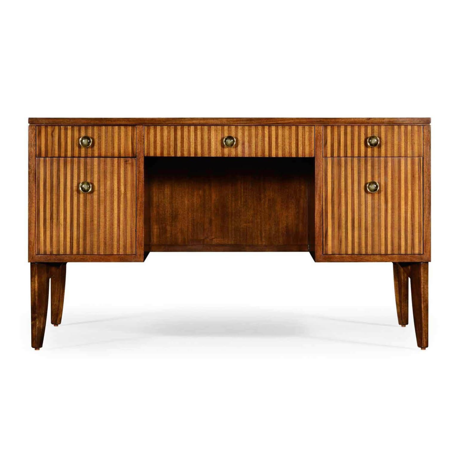 An unusual walnut leather top French Modern desk, with a handcrafted inset leather top, candy stripe inlaid front panels, crotch walnut sides, with five drawers each with a round Horn button pulls, on slightly splayed French legs with paisley drawer