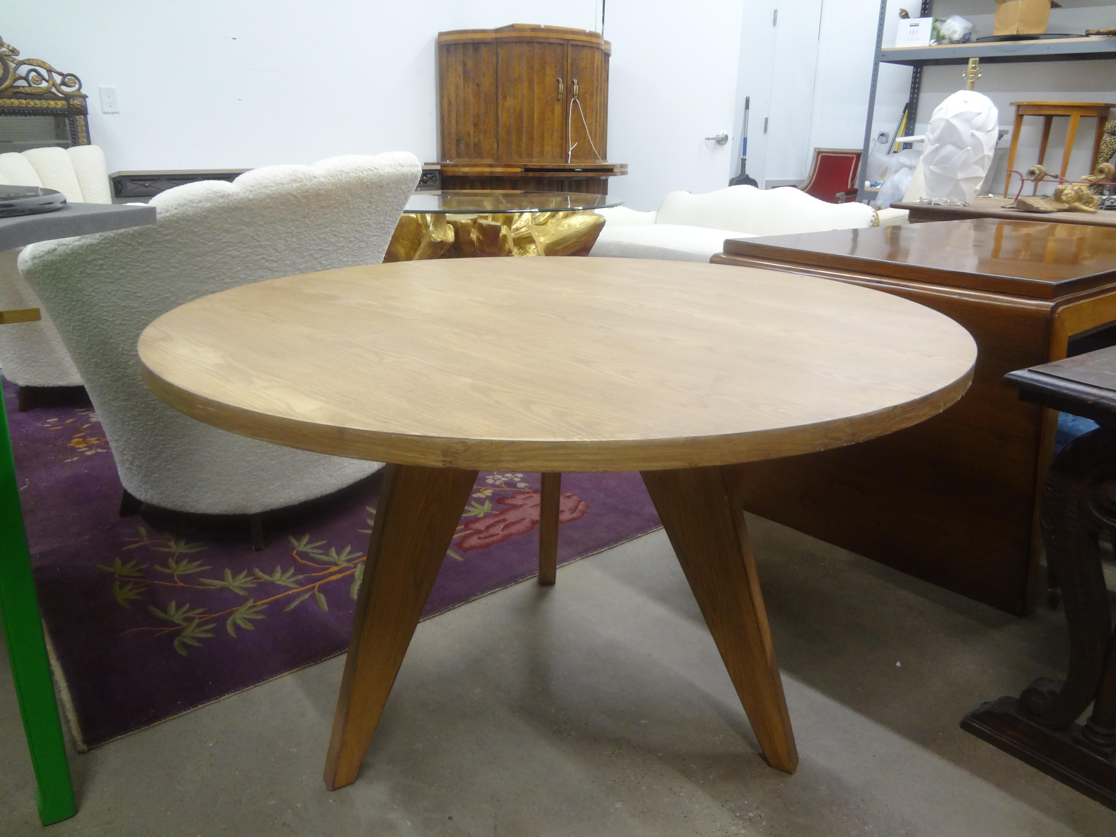 French Modern Pierre Chapo Inspired Elm And Iron Center Table. This versatile French mid century elm and wrought iron center table or dining table with beautiful tripod legs will work well in a variety of interiors and design themes.