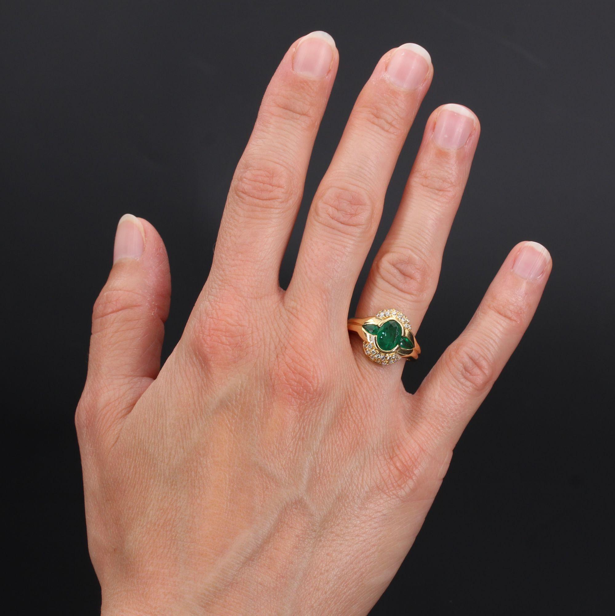 Ring in 18 karat yellow gold, eagle head hallmark.
This emerald ring is decorated with an oval emerald and emerald drops. It is bordered on each side by a pavement of brilliant-cut diamonds.
Weight of the main emerald : 0.85 carat approximately,