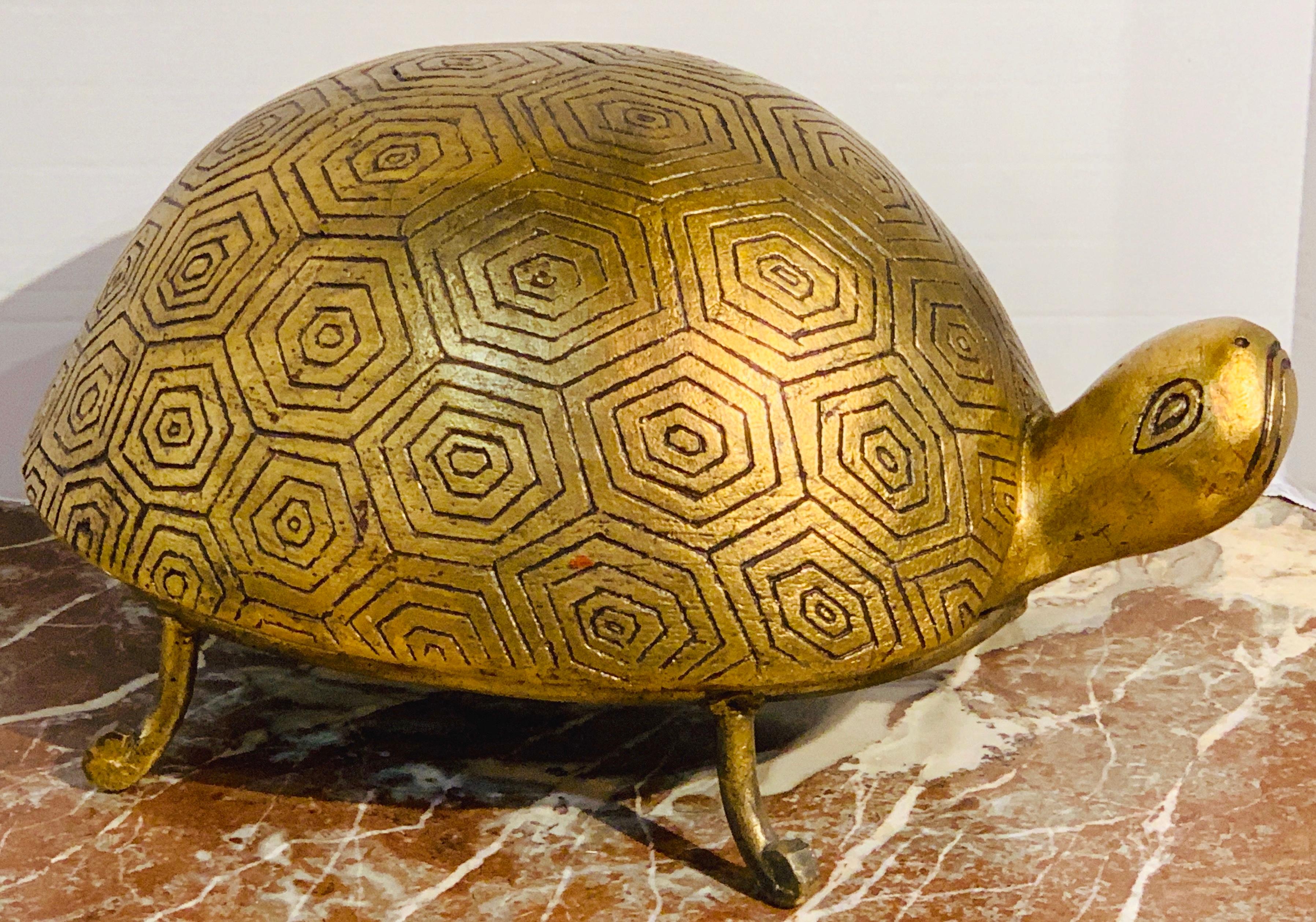 French Modern gilt lacquer terracotta and iron model of a turtle, in two parts, the beautifully incised decorated and gilt lacquer turtle, raised on a four leg gilt iron base. Retains vintage import label.
    