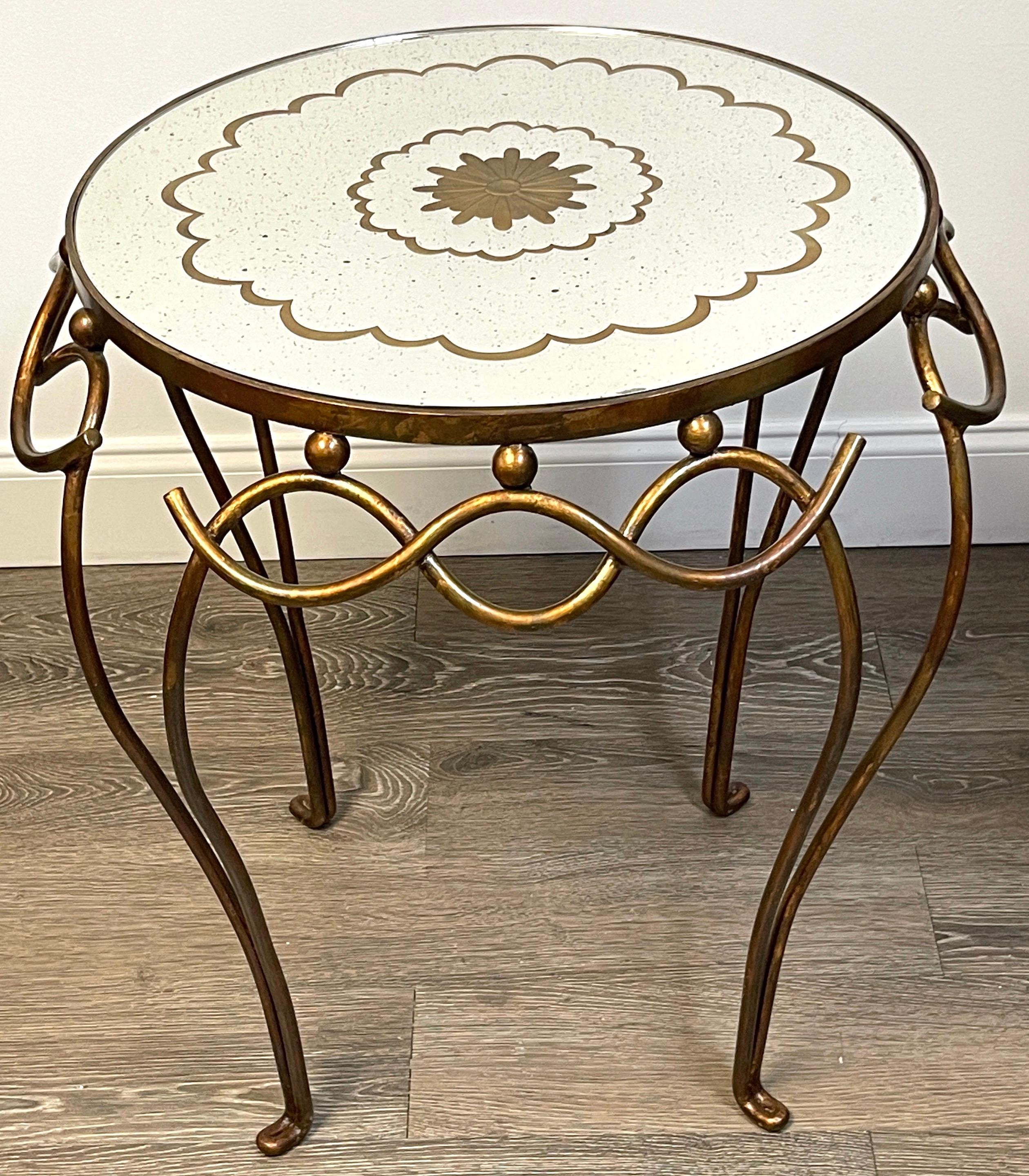 French Modern Gilt & Patinated Verre Églomisé side table, 
Style of René Drouet (1899-1993)
France, 20th Century
A beautiful stylish side/ end table, of circular form with inset (removable) Verre Églomisé Mirror decorated with gilt stylized