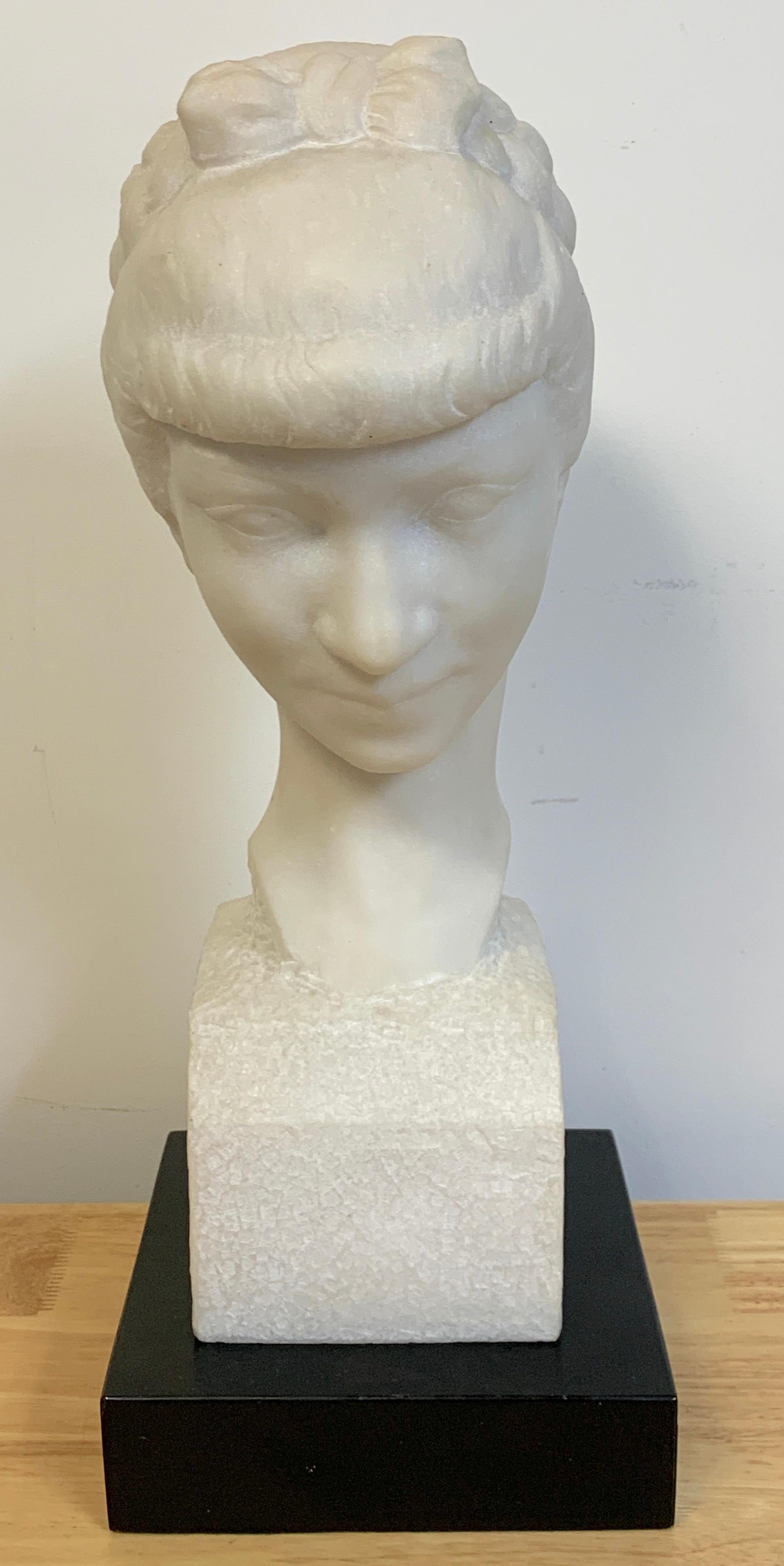 French modern marble portrait bust of a lady, by L. Cordonnier, '51 
A serene carved marble portrait bust of a young lady with braided hair looking downwards.
Signed L. Cordonnier, middle right
Included is a later ebonized wood plinth
Bust alone