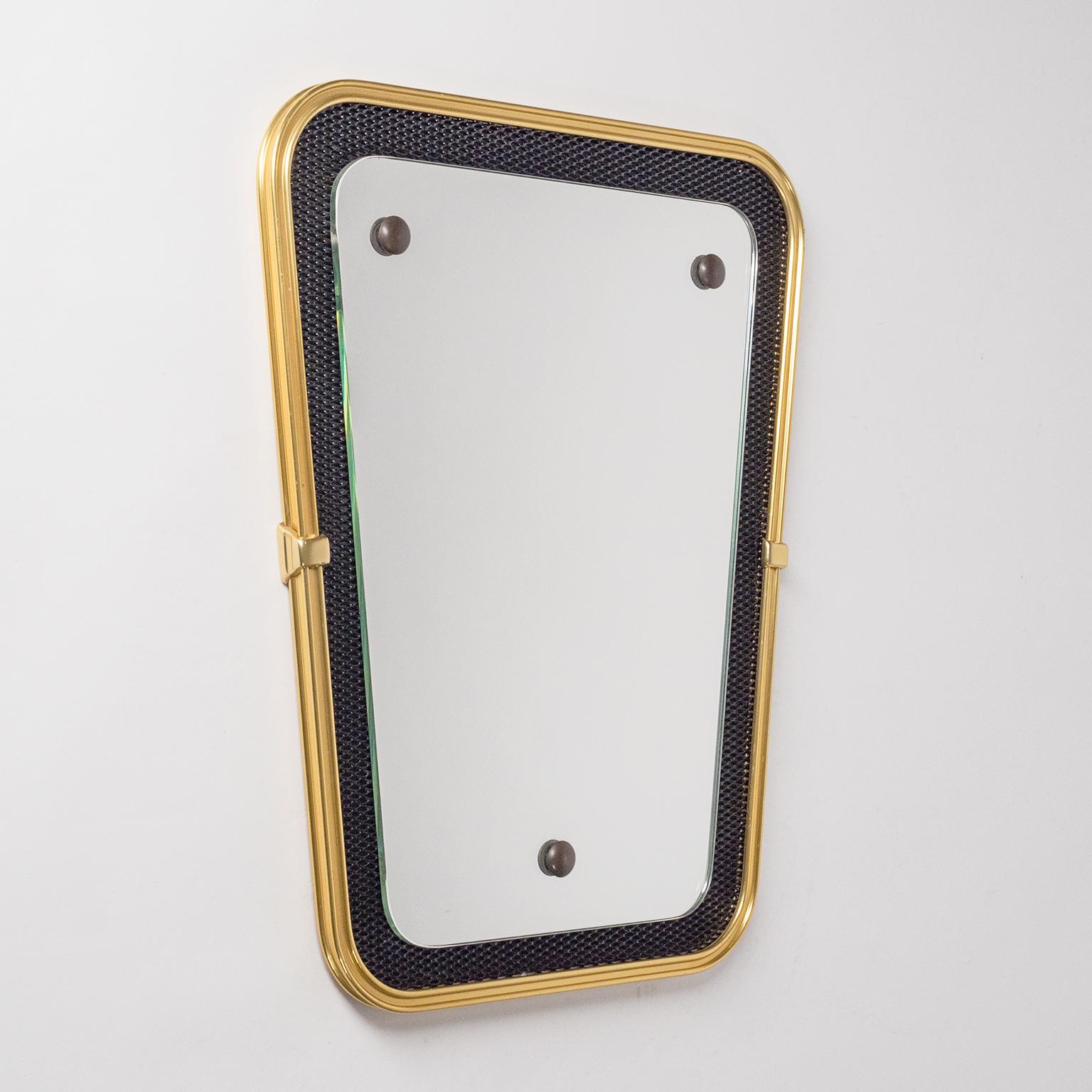 Charming French Modernist wall mirror with black lacquered expanded metal background, gold-anodized aluminum rim and brass details from the late 1950s-early 1960s. Very good original condition with some minor wear. Mirror measures: 16inches/40cm in