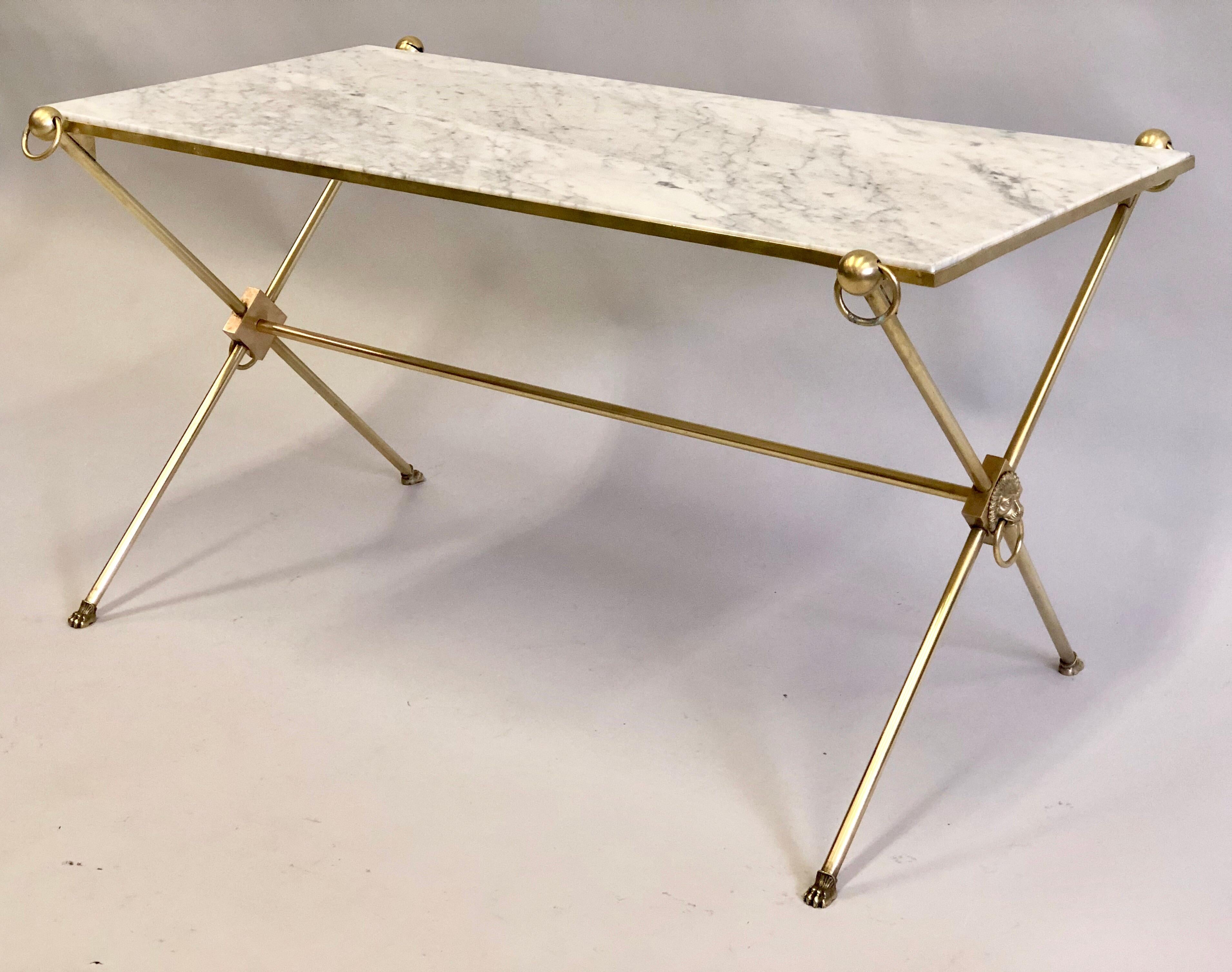 Elegant French Mid-Century Modern Neoclassical solid brass and Italian marble coffee table by Maison Jansen, circa 1950. A classic, yet modern design with pure, timeless materials. The frame is constructed of solid brass with white Italian Carrara
