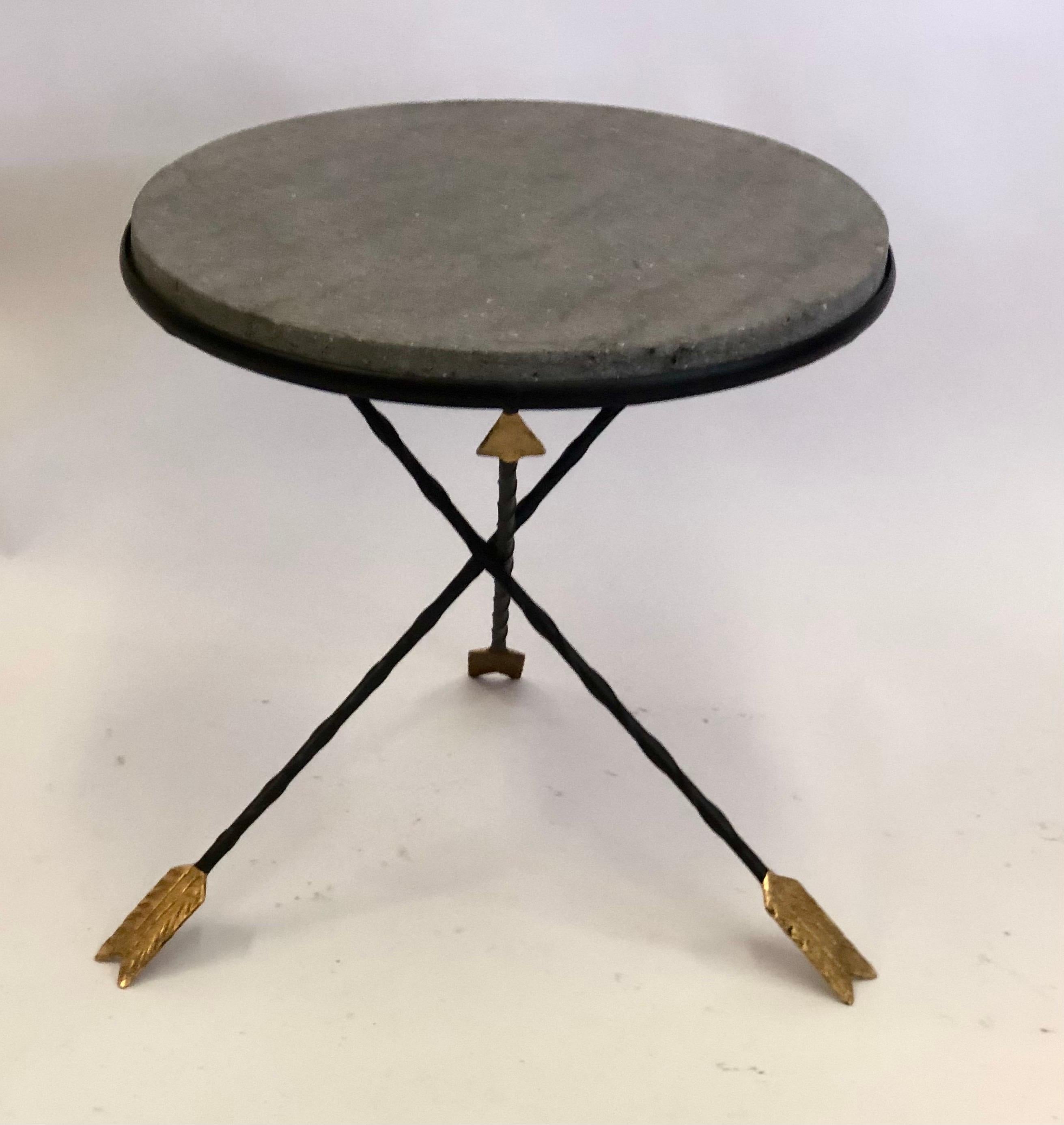 French Mid-Century Modern neoclassical partially gilt wrought iron gueridon or side / end table by Maison Jansen. A dramatic piece that features a top of rich, natural basalt stone inset into a tripod wrought iron base supported by 3 partially gilt
