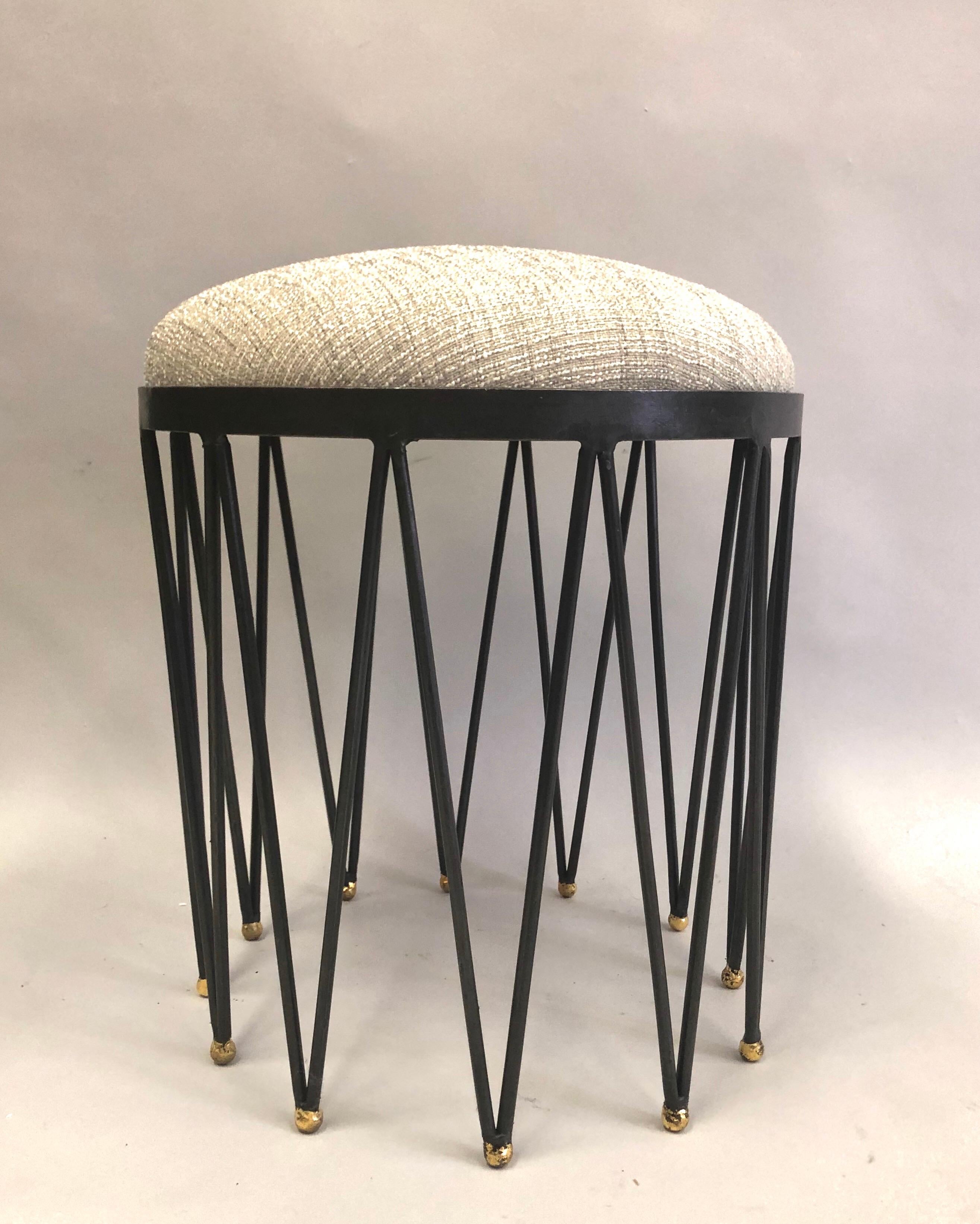 2 elegant and timeless French modern neoclassical gilt iron stools or benches attributed to Gilbert Poillerat. The pieces of a wood and upholstery seat set into a unique handwrought iron frame in lozenge pattern ending in round ball feet that have