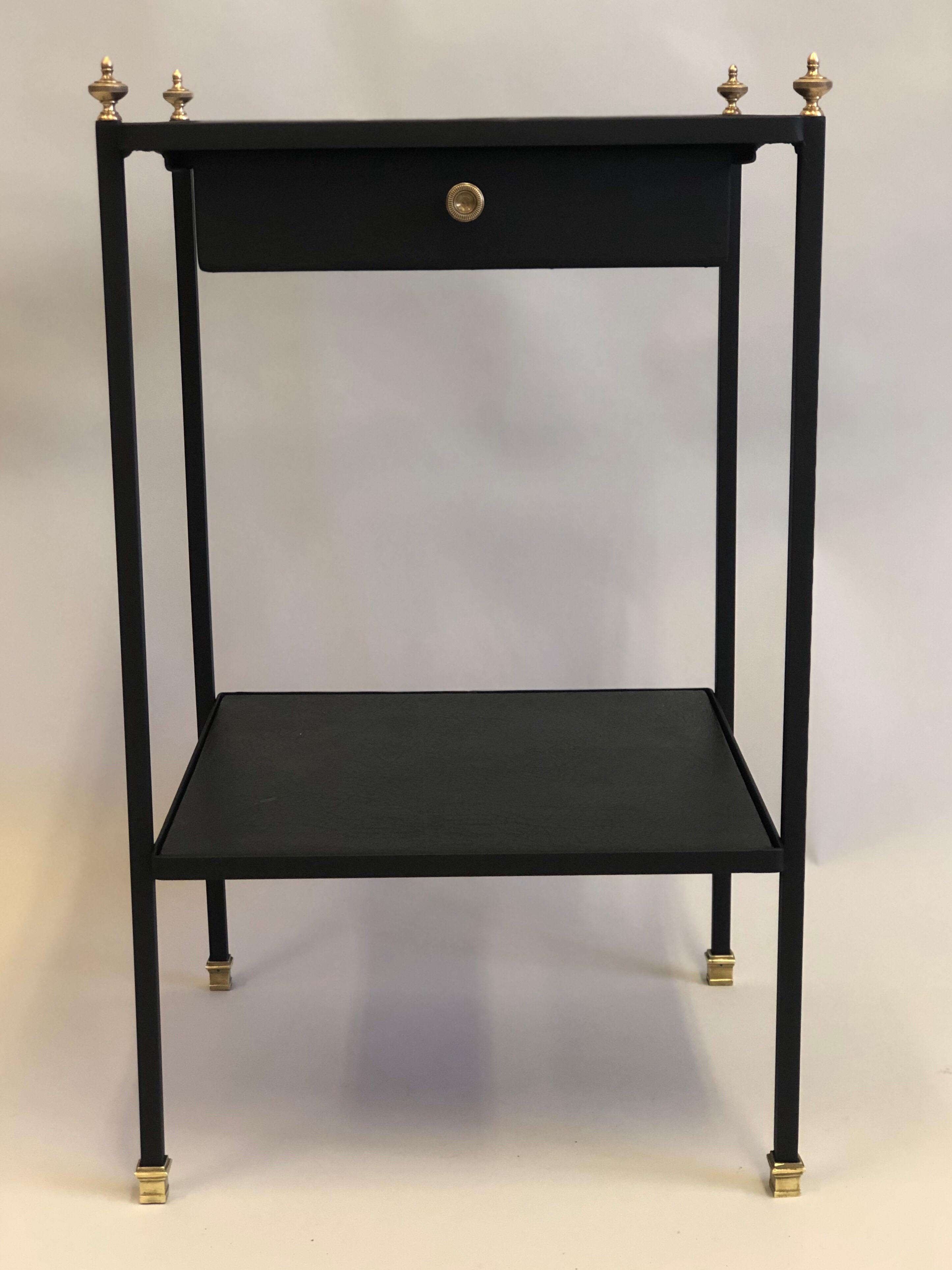 Elegant, Sober French Mid-Century Modern neoclassical black iron and faux black leather side or end table / nightstand by Jacques Adnet with exquisite lines and profile. 

The drawer is suspended beneath the top level and is delicately spaced
