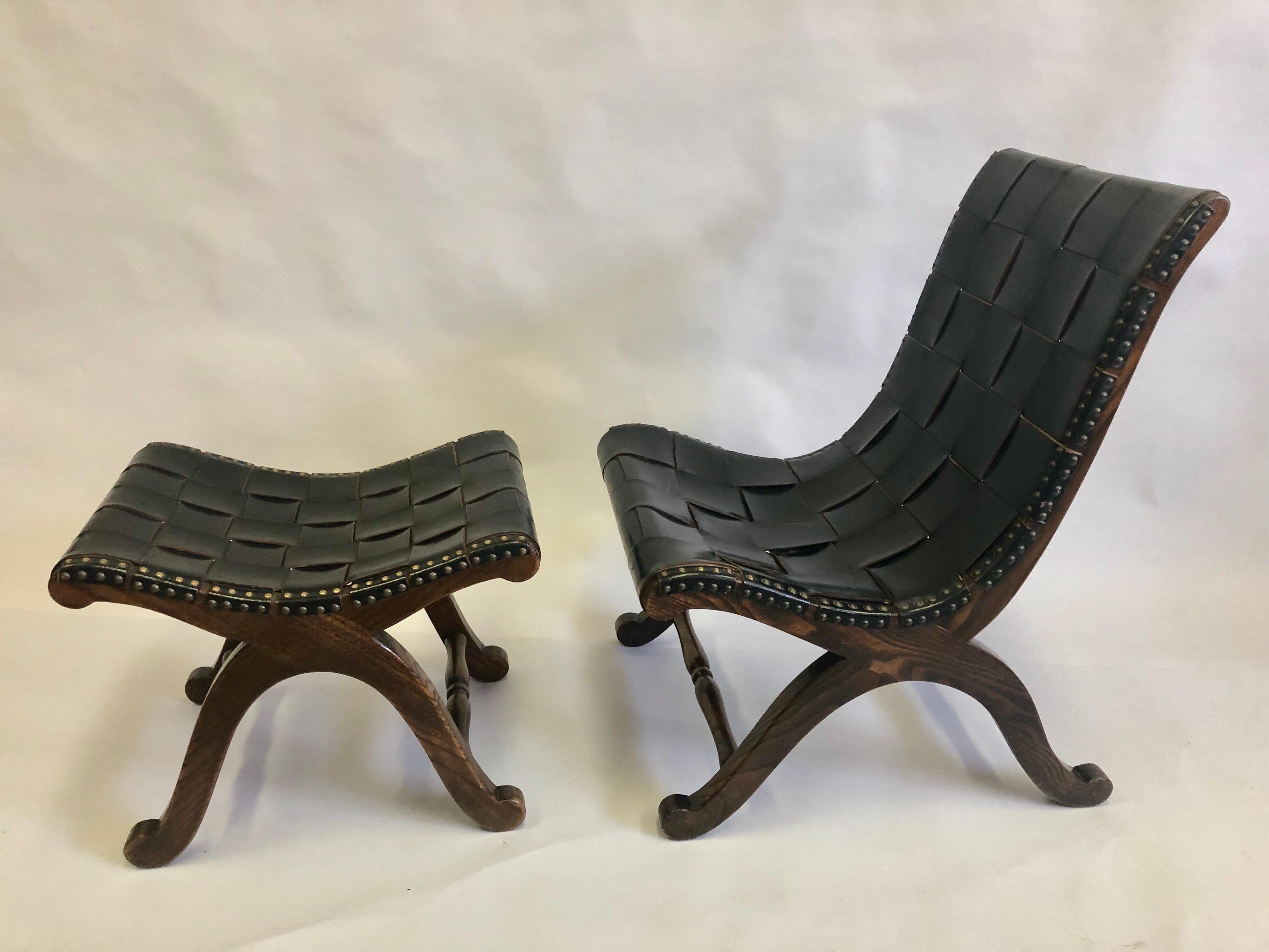 French Mid-Century Modern Neoclassical black leather strap lounge / slipper chair and ottoman / stool attributed to Pierre Lottier featuring a solid hard wood frame constructed in a curile X form. 

The chair and ottoman / stool are interlaced with