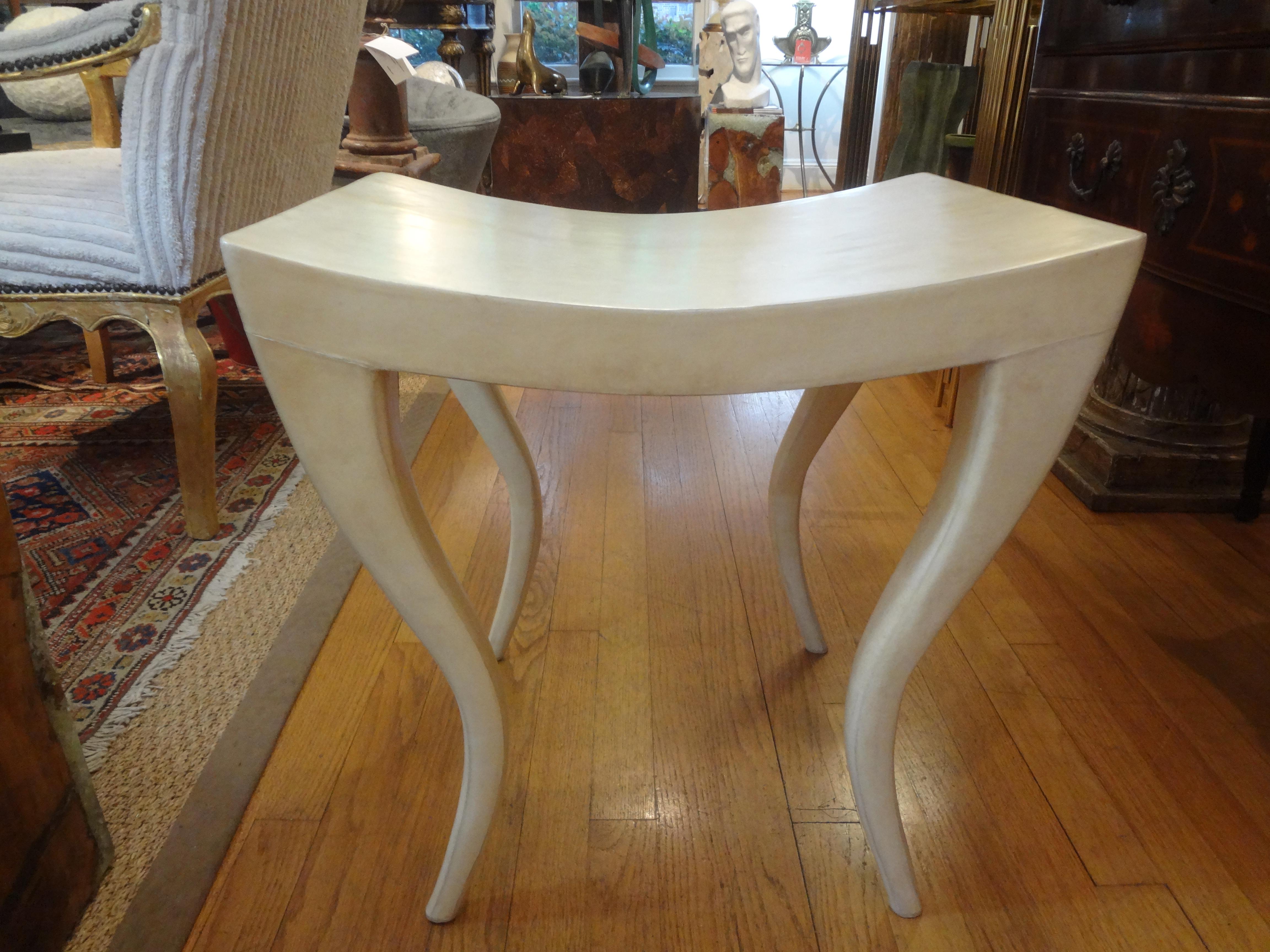 French modern parchment bench by R&Y Augousti. This stunning bench has beautiful saber legs. This lovely postmodern French bench can also be used as a side table. Stamped on the bottom R&Y Augousti Paris.