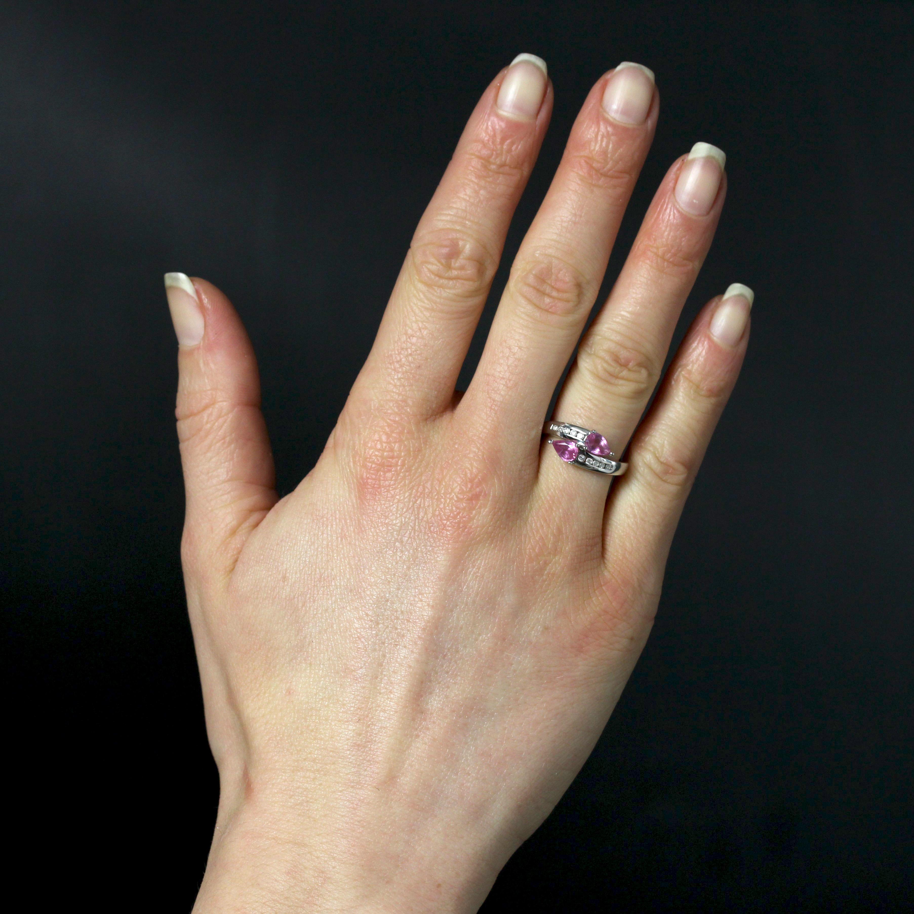 Ring in 18 karat white gold, eagle head hallmark.
You and Me ring in white gold, set with three claws at the top with two pear-cut pink sapphires. The base of the ring is rail-set on either side with 2 x 5 modern brilliant-cut diamonds.
Weight of