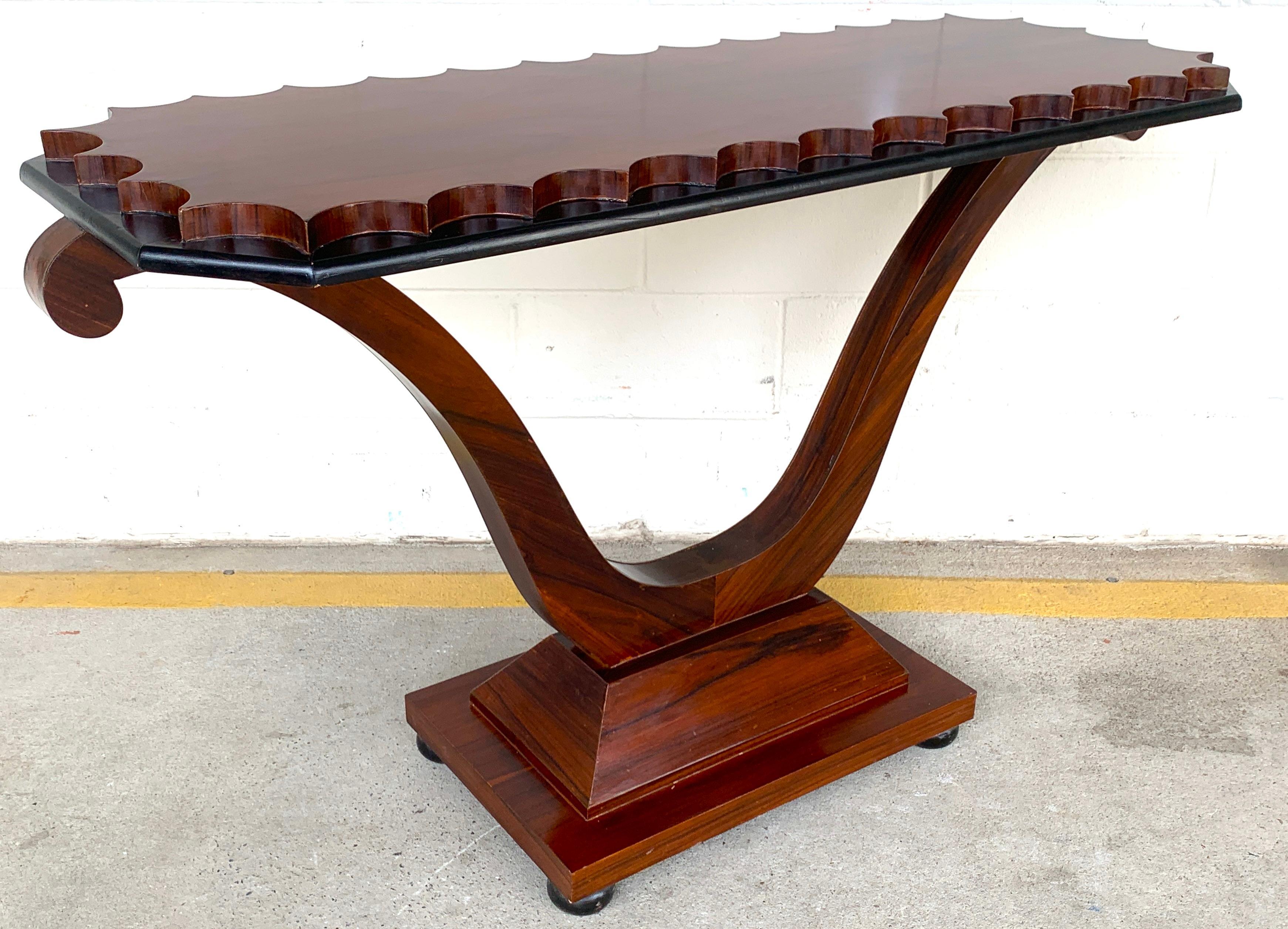 French Modern rosewood scalloped console table
With beautifully figured scalloped top, raised on lyre pedestal base
The console measures: 54