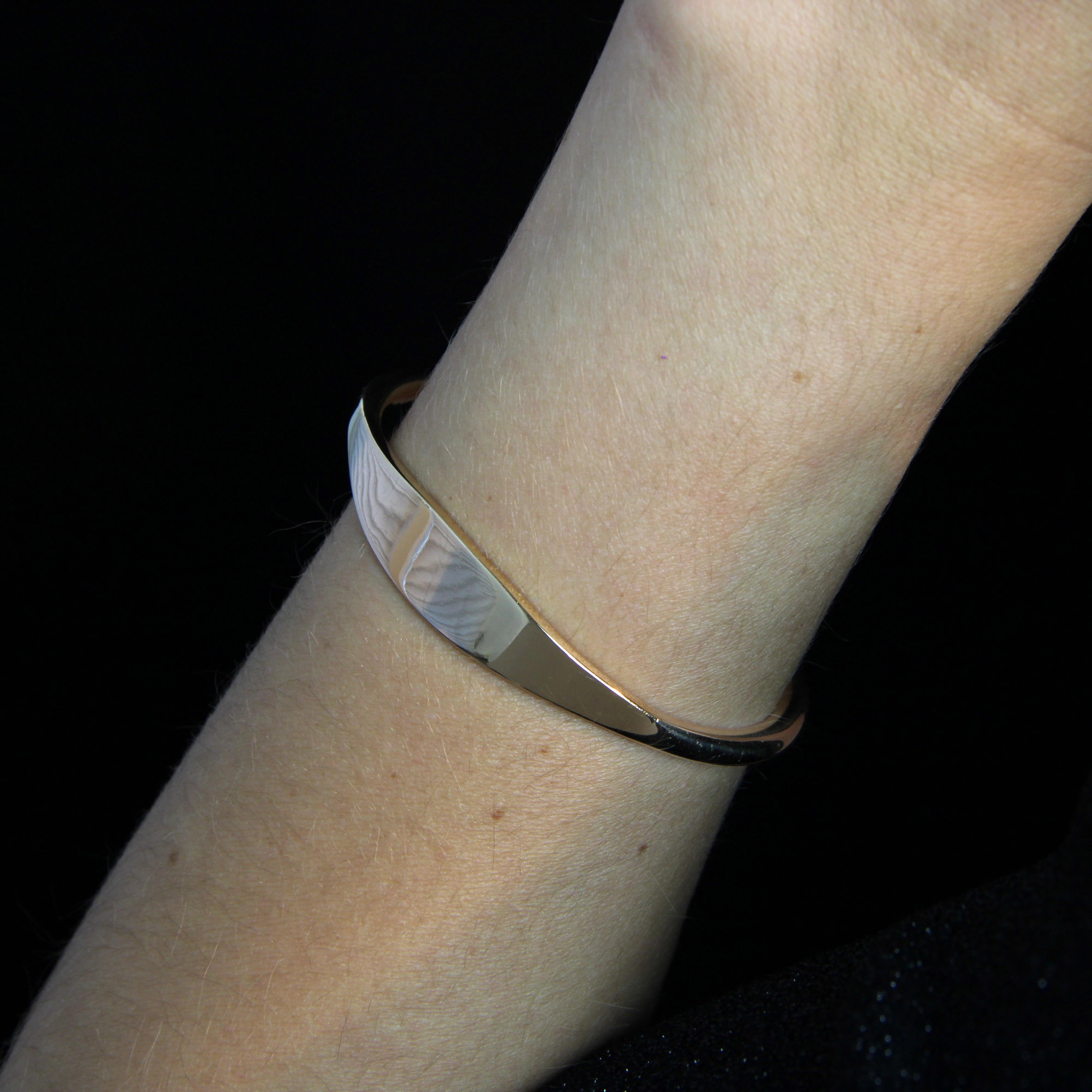Armband aus 18 Karat Gelbgold, Adlerkopfpunze.
Dieser ovale Perlenring aus Gelbgold ist an der Basis zum Auffädeln offen. Jedes Ende ist mit einer goldenen Perle verziert, während die Oberseite breiter ist, damit Sie Ihre Initialen, ein Motiv oder