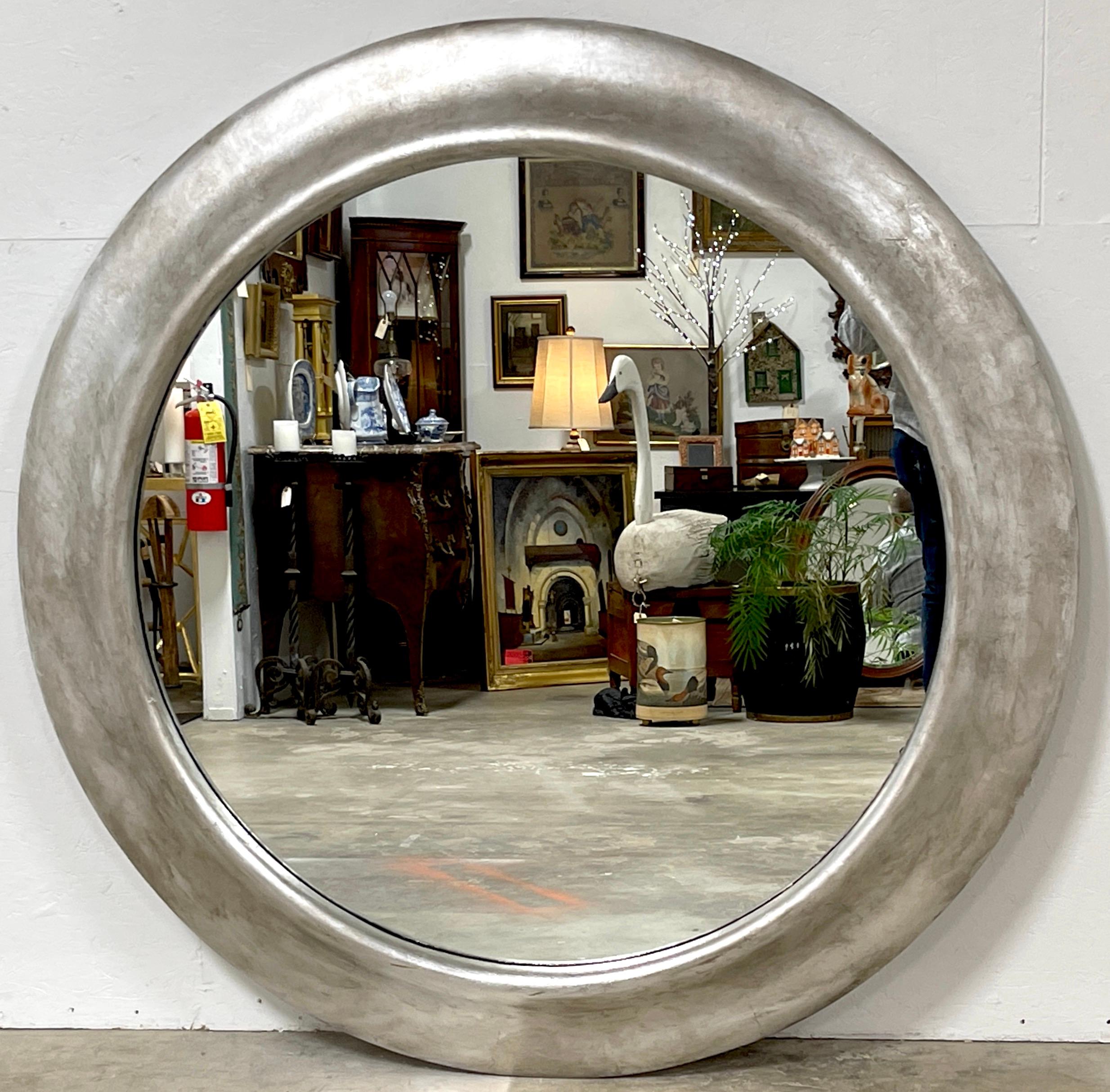 Monumental French Modern Silverleaf  Round Mirror
Purchased in France 1970s
A rare find, we are please to offer this stunning large scale French Modern silver-leaf  round mirror. 
The 58- Inch diameter  sleek rounded oblique silver-leaf (7-Inches