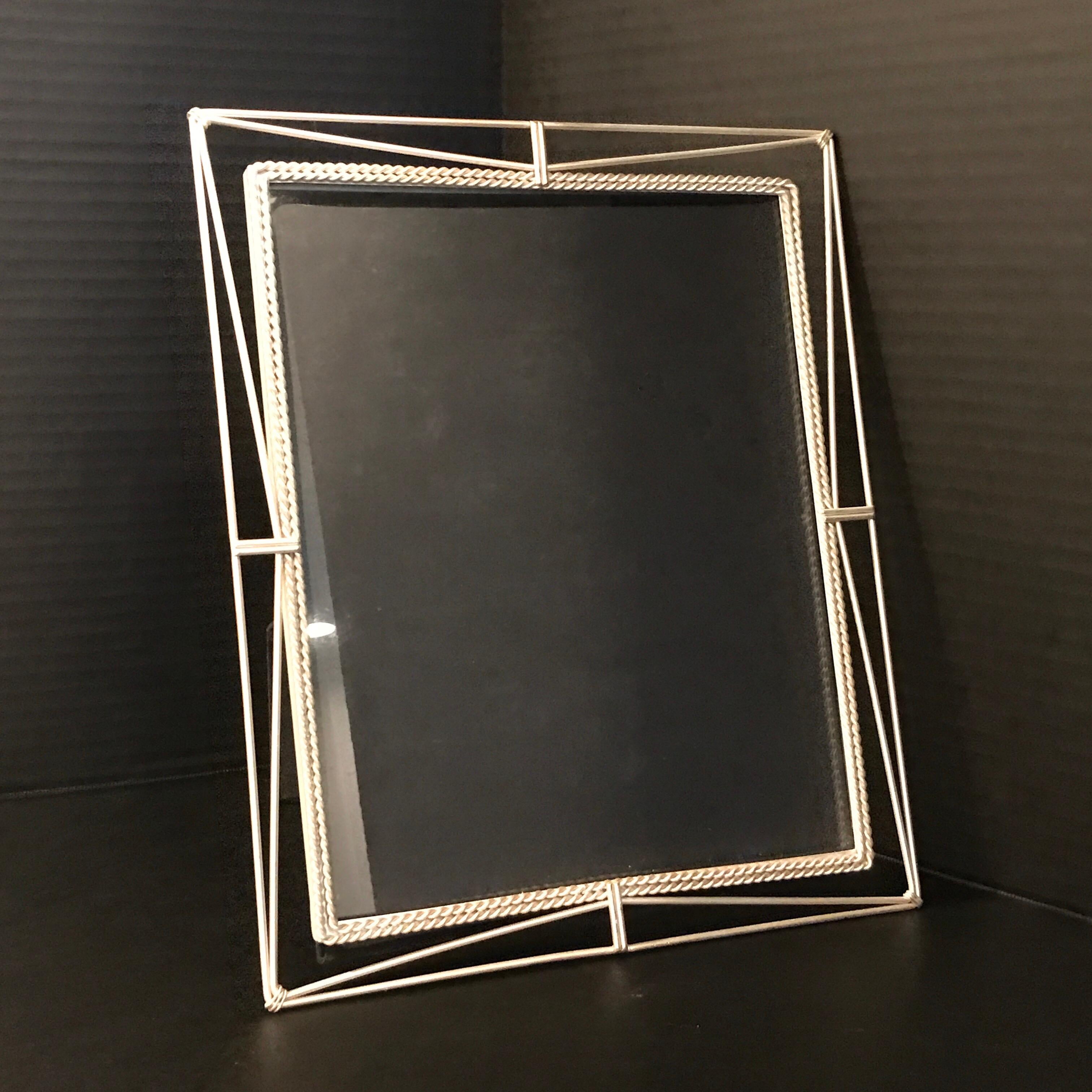 French modern silver plated frame, with rope and twine motif, holds a 8