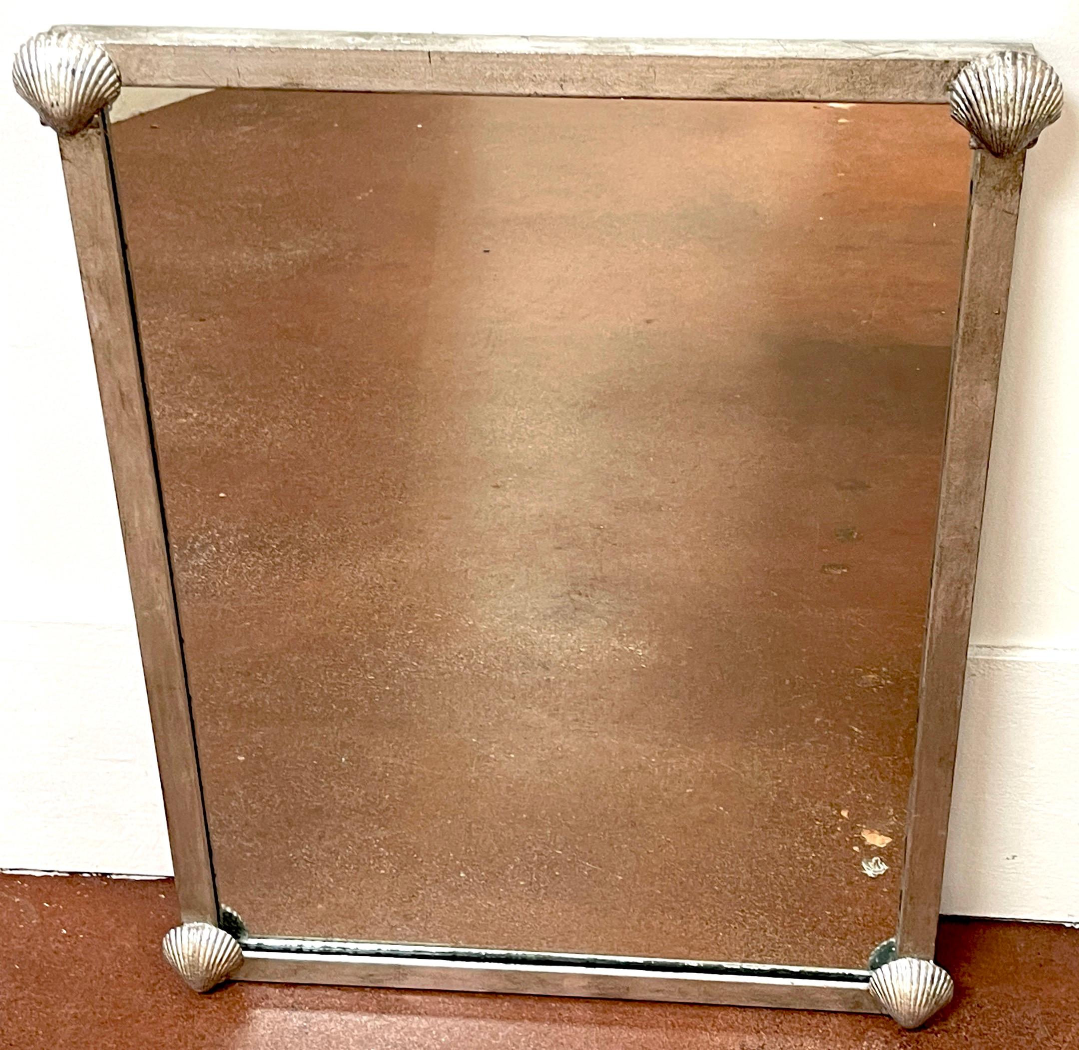French Modern Silvered Metal Shell Motif Mirror, Second Mirror Available 
France, Circa 1960s
Each one of rectangular form with four finely cast sea shells at each corner, holding a inset 24-inch wide x 33-inch high mirror. Ready to hang. Sold